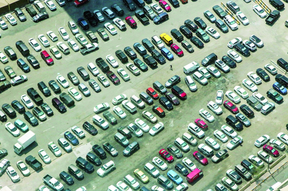 A picture taken on August 31, 2021, from the top of Al-Hamra Tower shows a parked cars in Kuwait City. Al-Hamra tower is the tallest skyscraper in Kuwait and one of the top 10 tallest towers in the world. (Photo by YASSER AL-ZAYYAT / AFP)

