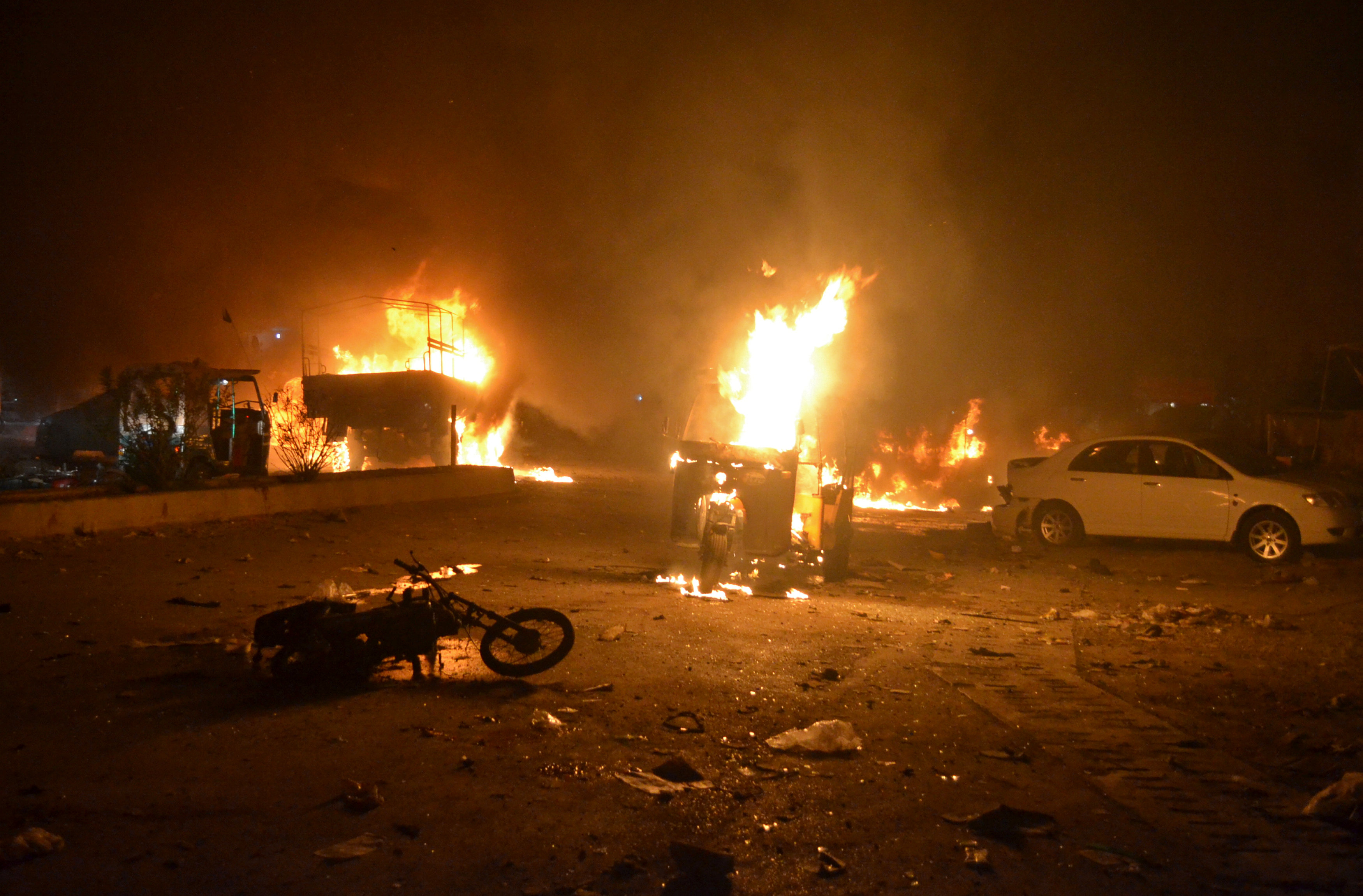 Vehicles are seen burning after a bomb blast in Quetta,
