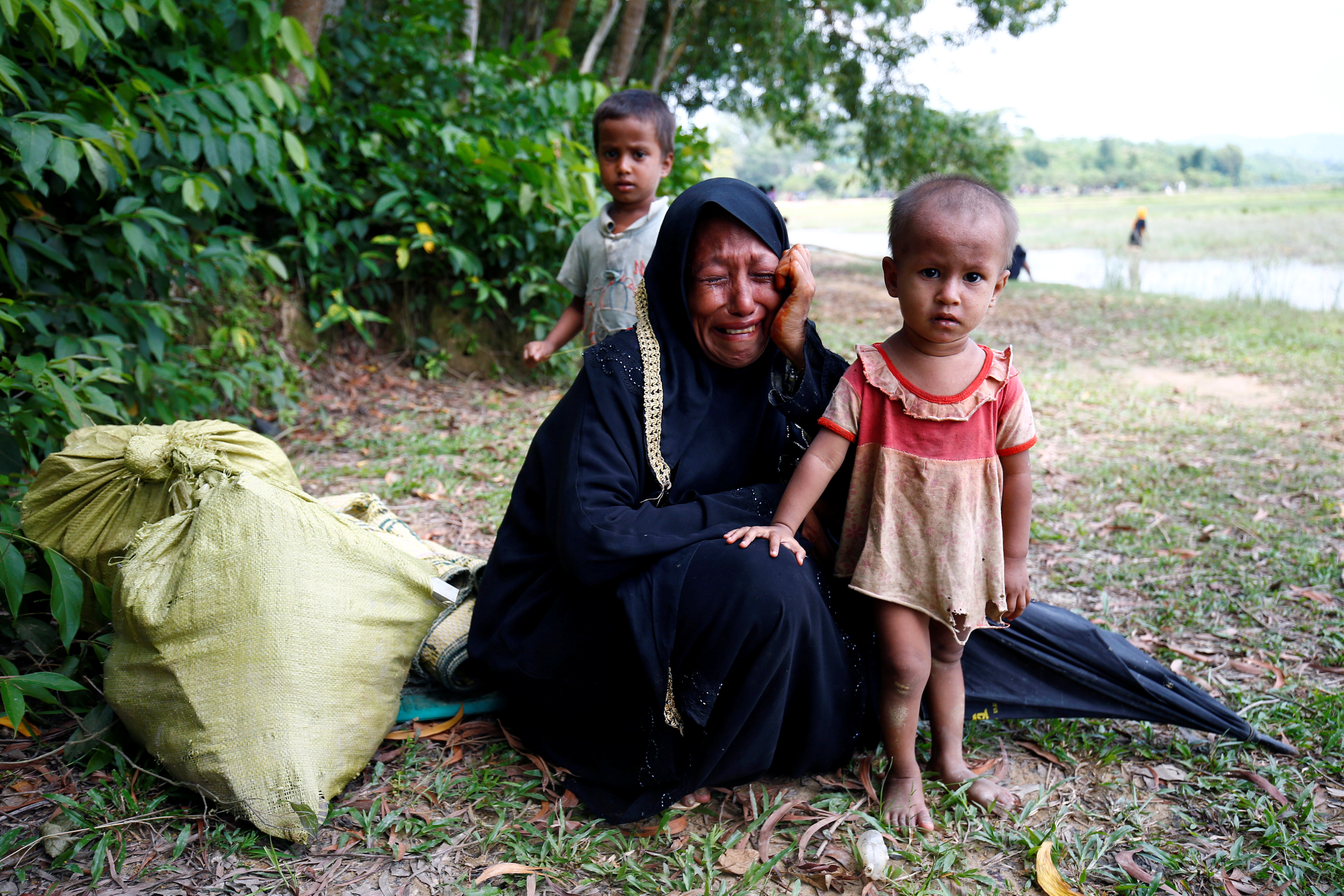 Rohingya woman cries with her child after being restricted by BGB to further enter the Bangladesh side, in Cox?s Bazar