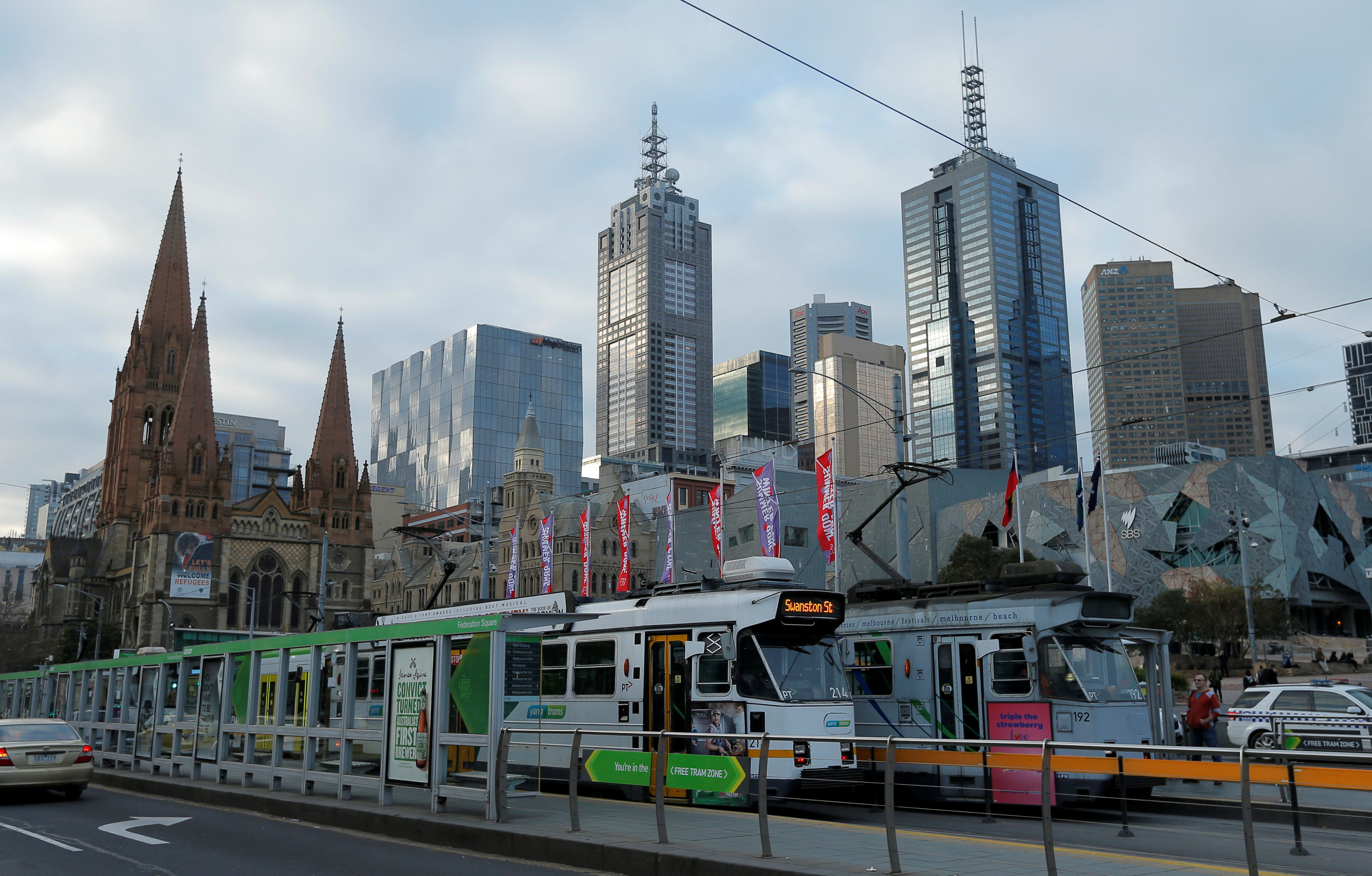 FILE PHOTO: Trams pass by Melbourne's city skyline in Australia's second-largest city