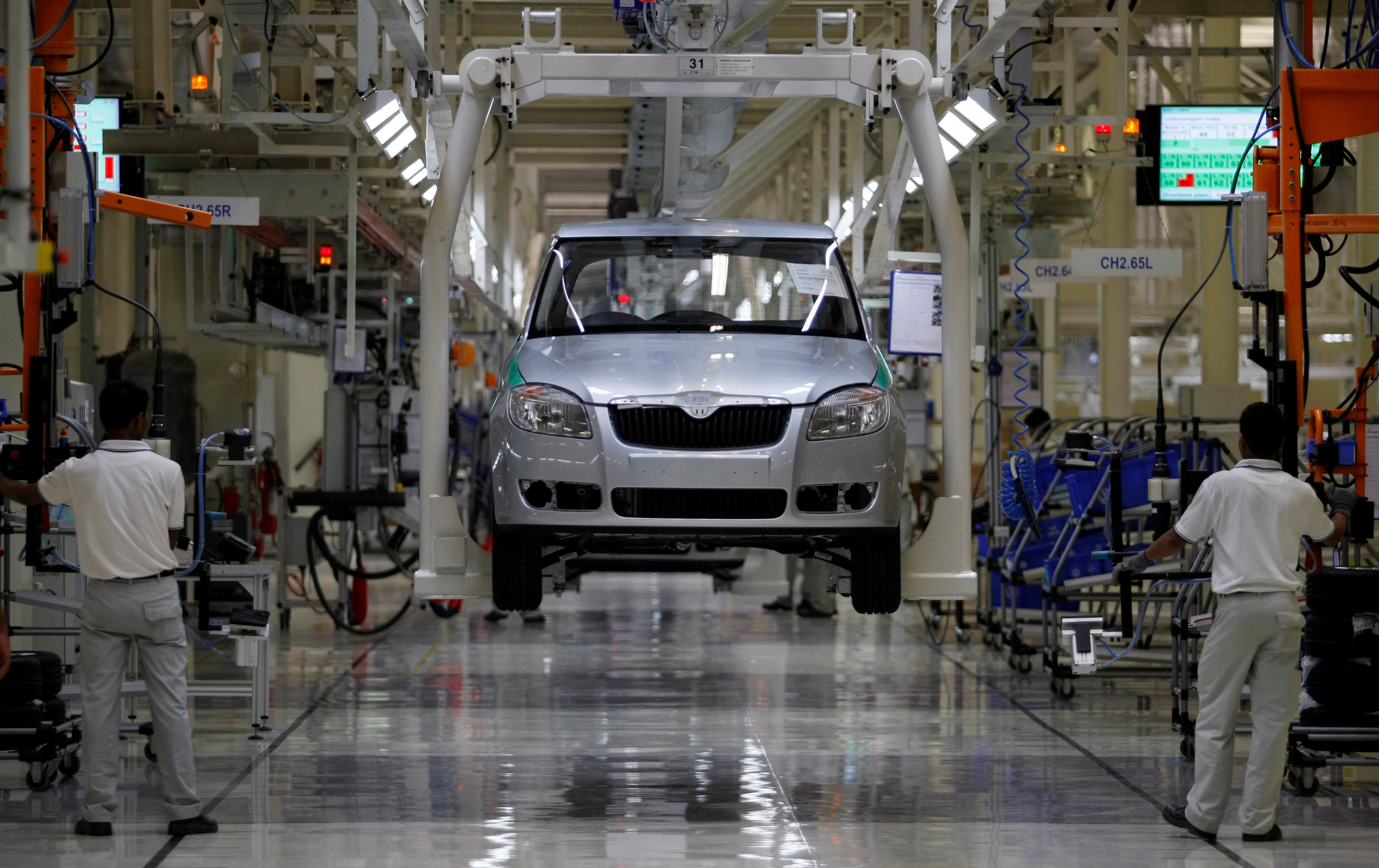 FILE PHOTO: Employees work at assembly line at Volkswagen's plant in Chakan
