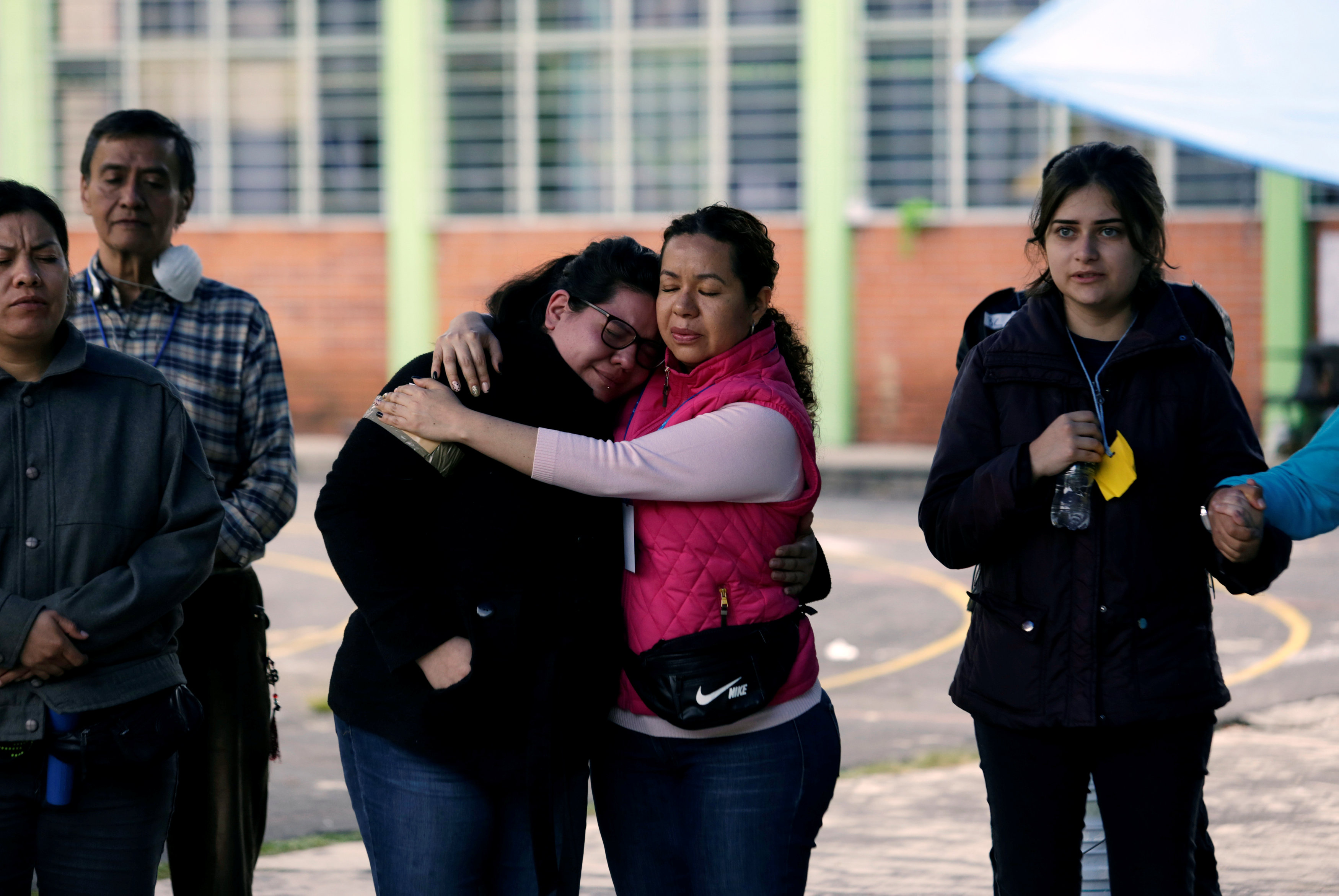 People who are living in a shelter because their homes were damaged in an earthquake, are united in a prayer after a tremor was felt in Mexico City