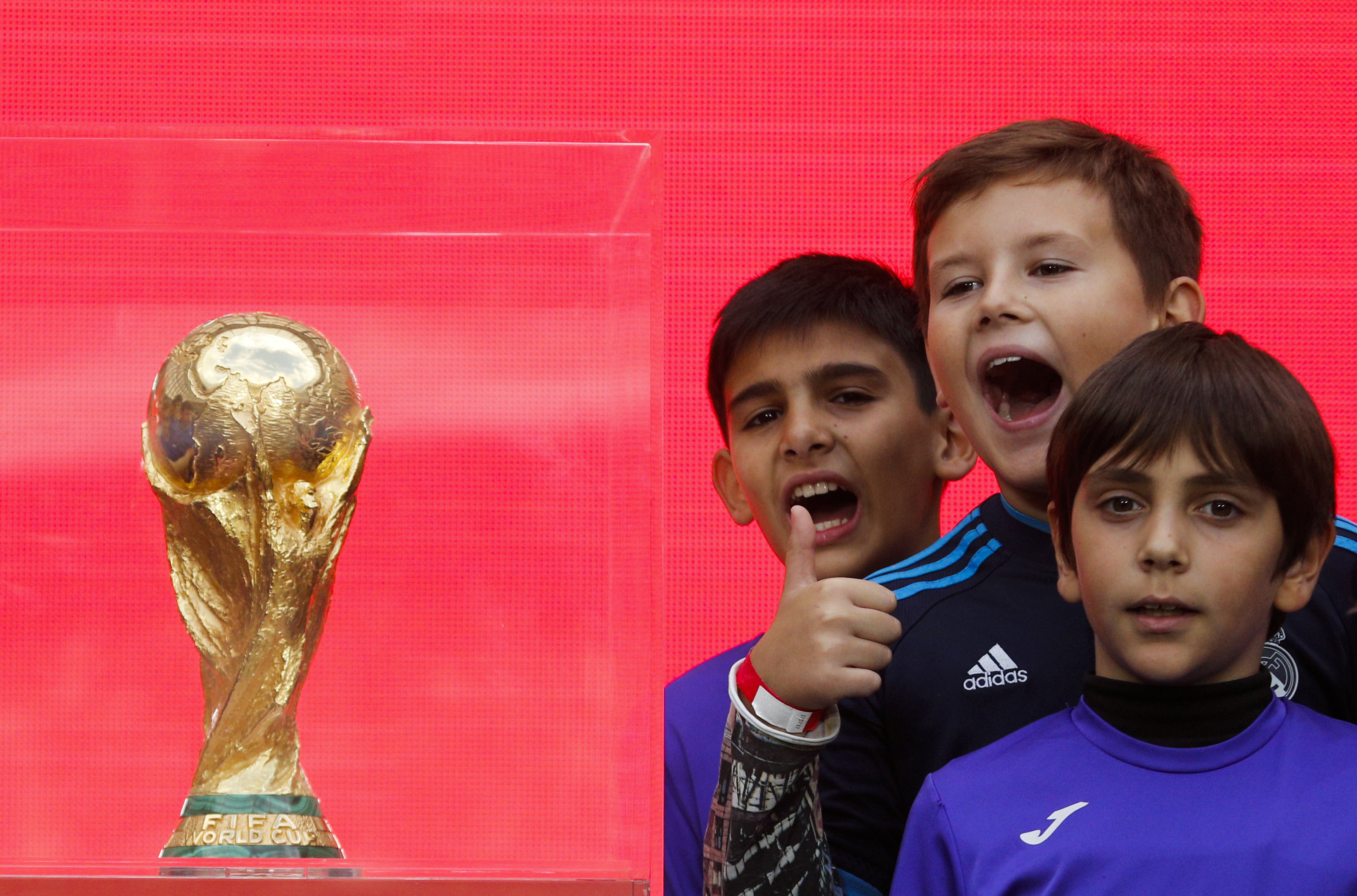 Children pose for a photo during the FIFA World Cup Trophy Tour kick-off ceremony at the Luzhniki Stadium which will host matches of the 2018 FIFA World Cup, in Moscow