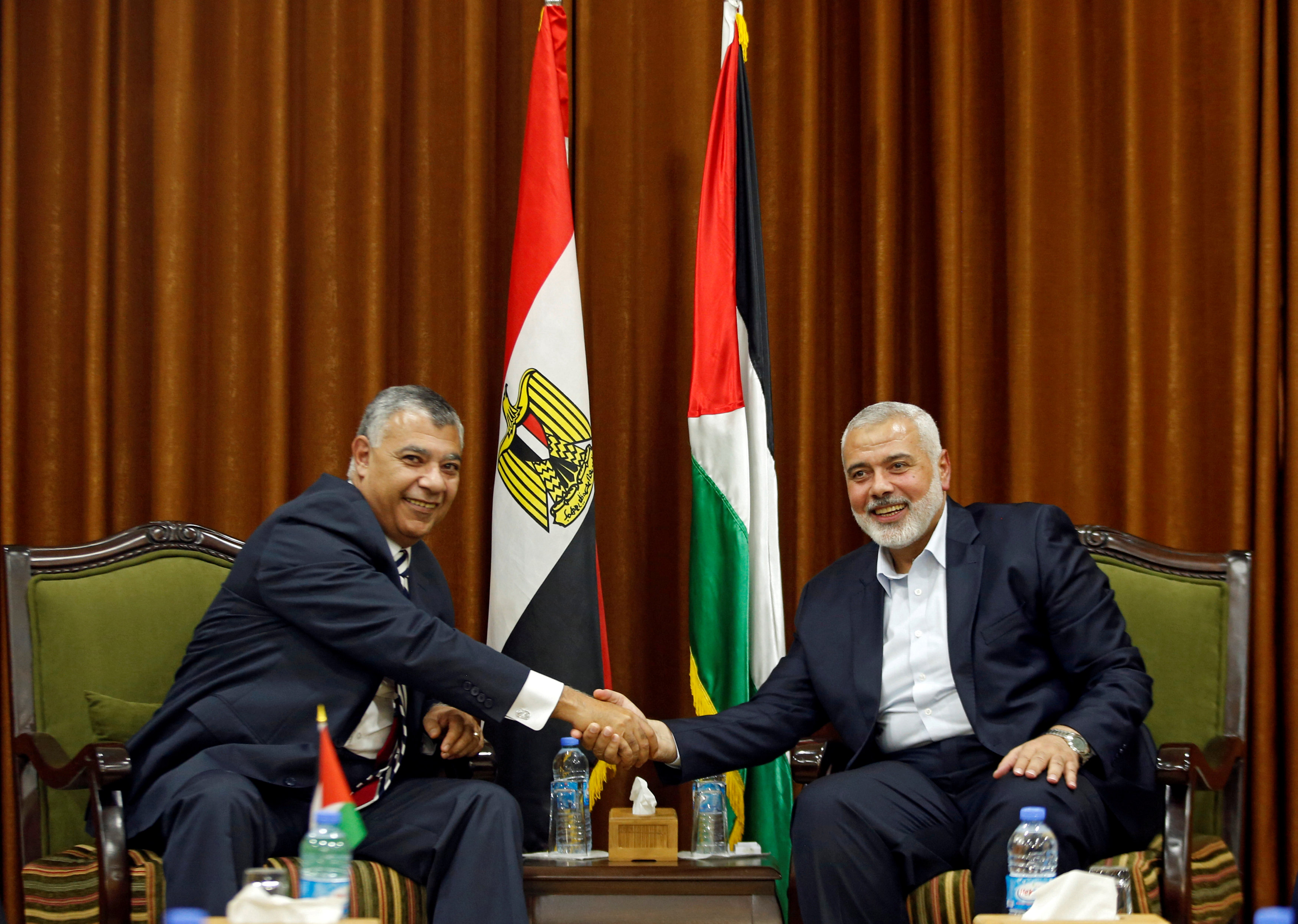 FILE PHOTO: Palestinian Hamas Chief Haniyeh shakes hands with Egyptian intelligence chief Fawzi in Gaza City