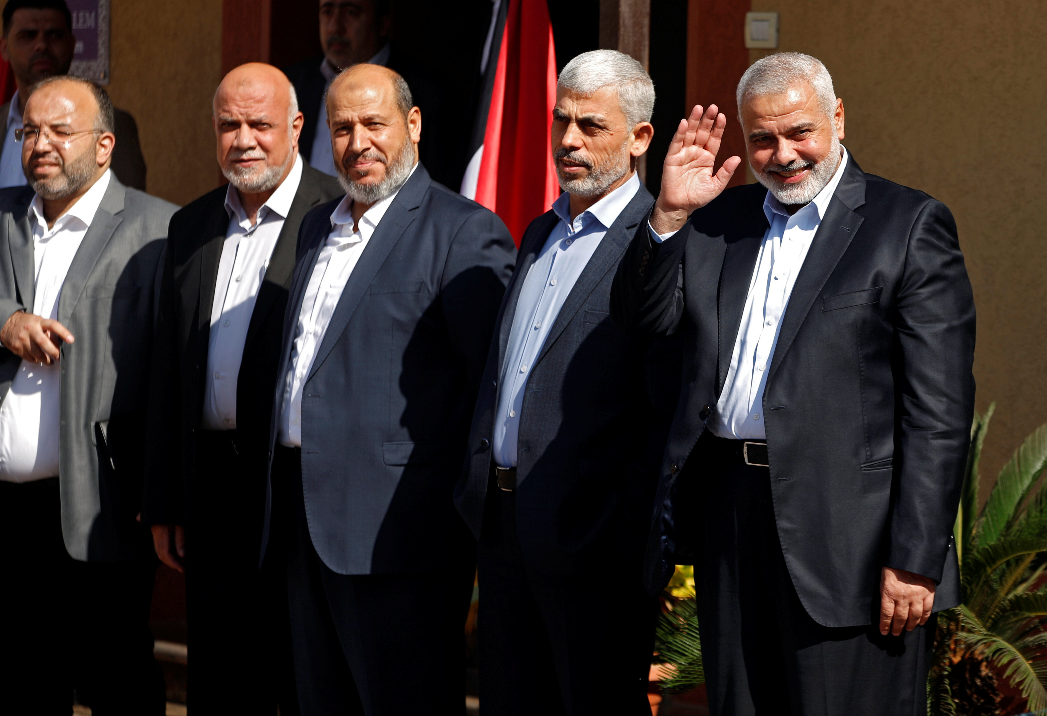Palestinian Hamas Chief Ismail Haniyeh waves as he and senior Hamas leaders wait for the arrival of Egyptian intelligence chief Khaled Fawzi in Gaza City