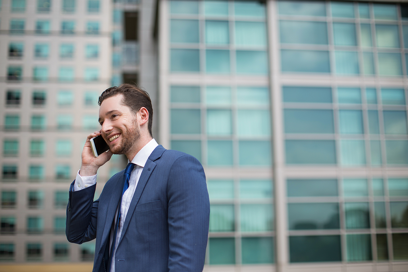 Smiling Business Man Talking on Phone Outside