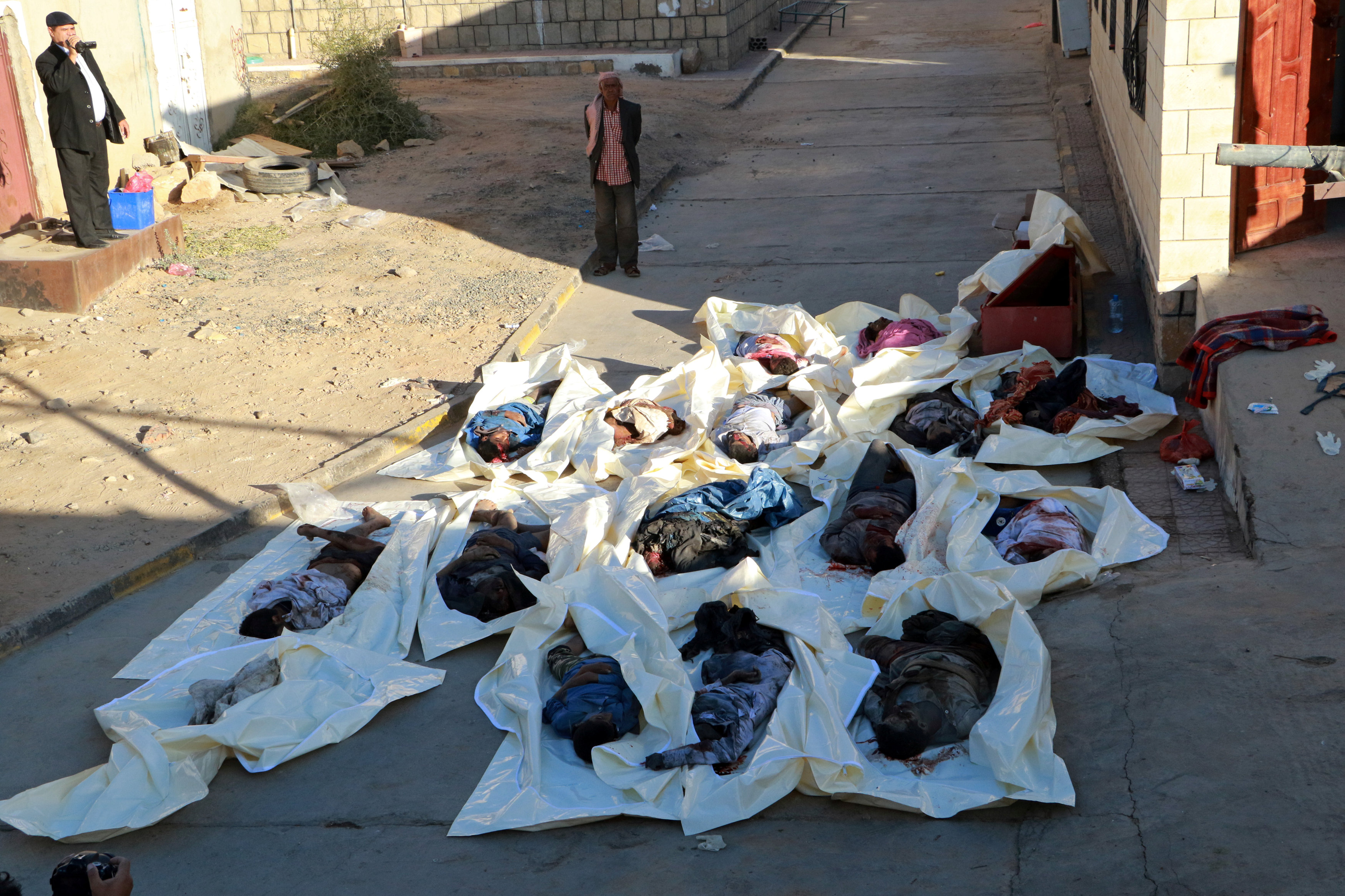 Bodies of men killed by an air strike are seen at the yard of a hospital morgue in the northwestern city of Saada