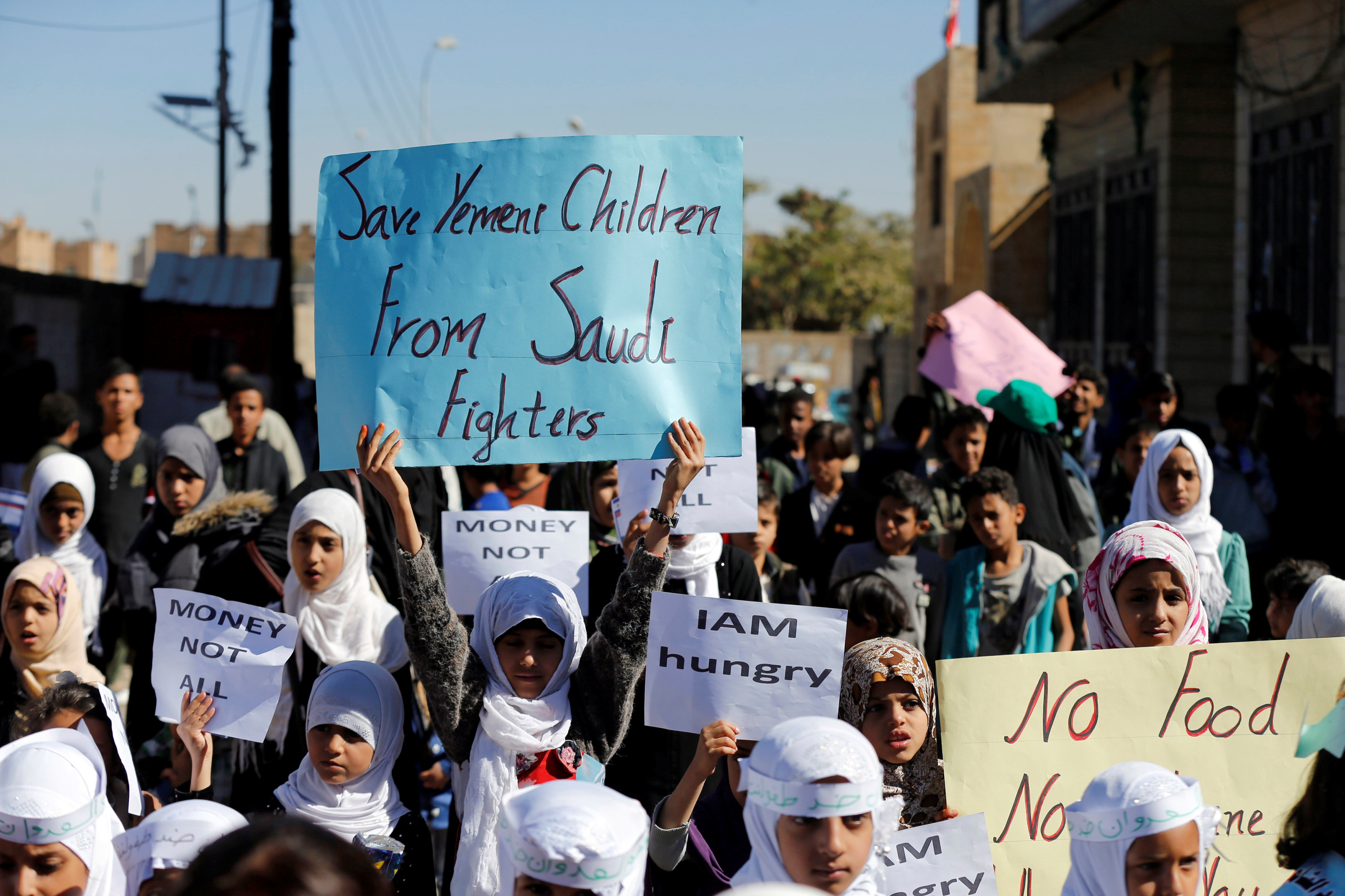 Children protest against the Saudi-led coalition outside the U.N. offices in Sanaa