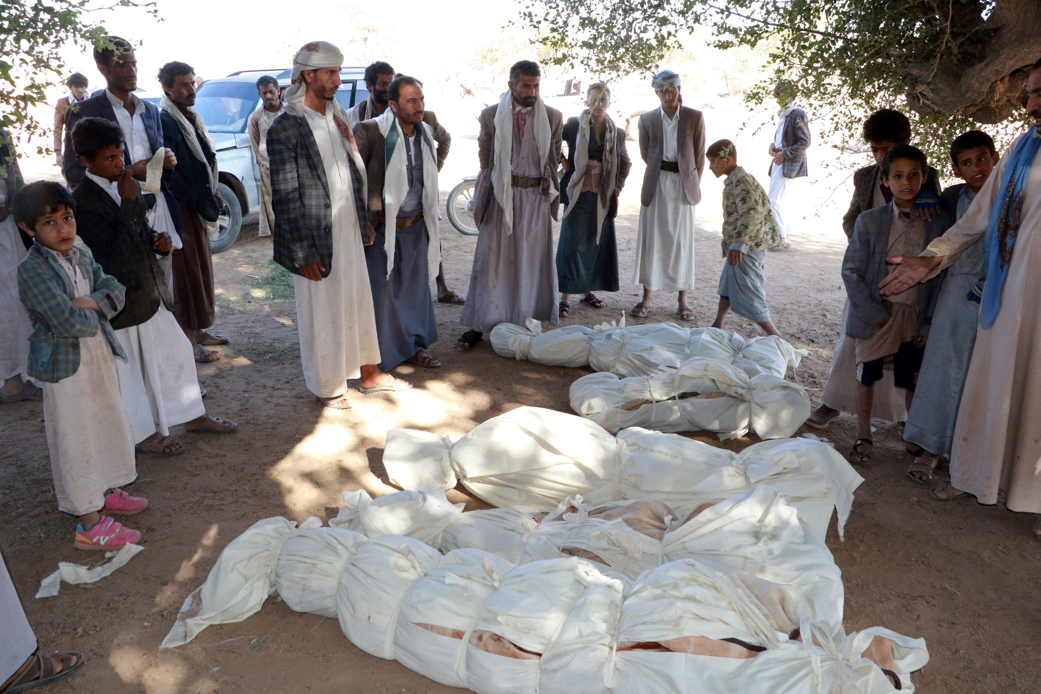 Corpses of people killed by an air strike are laid on the ground in the northwestern city of Saada