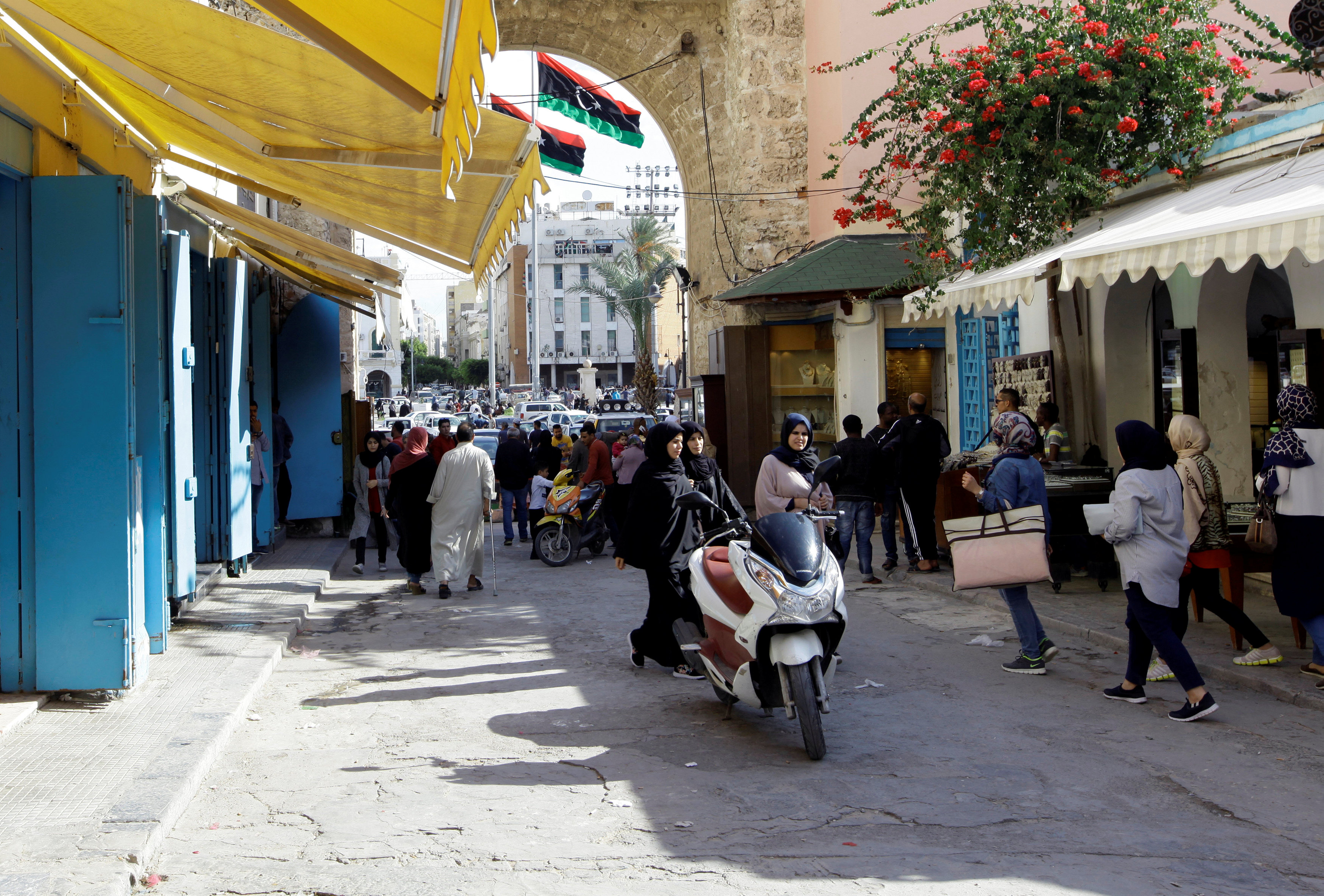 People walk at a market in the old city of Tripoli