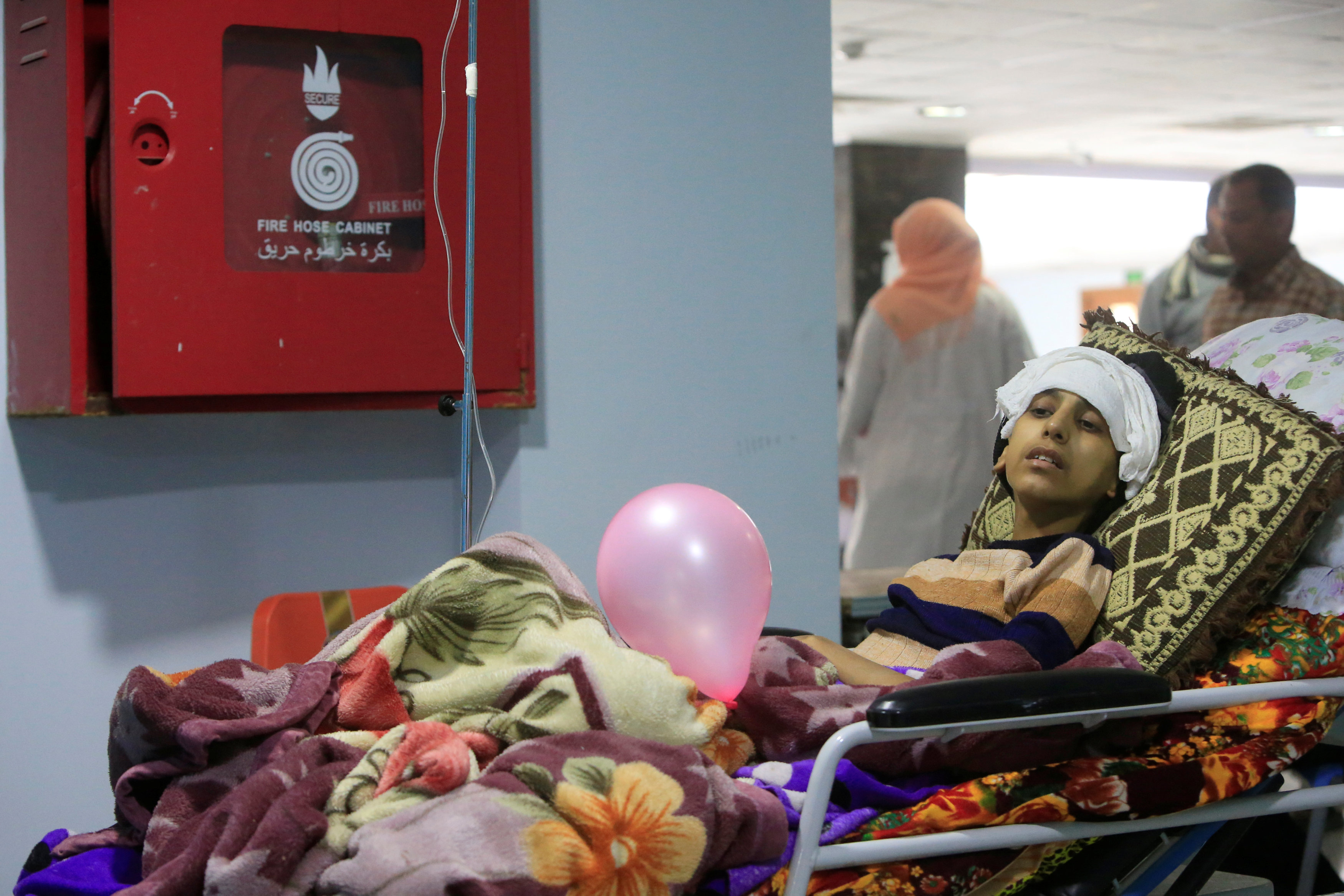 A cancer patient lies on a bed at a cancer treatment center in a hospital in Najaf