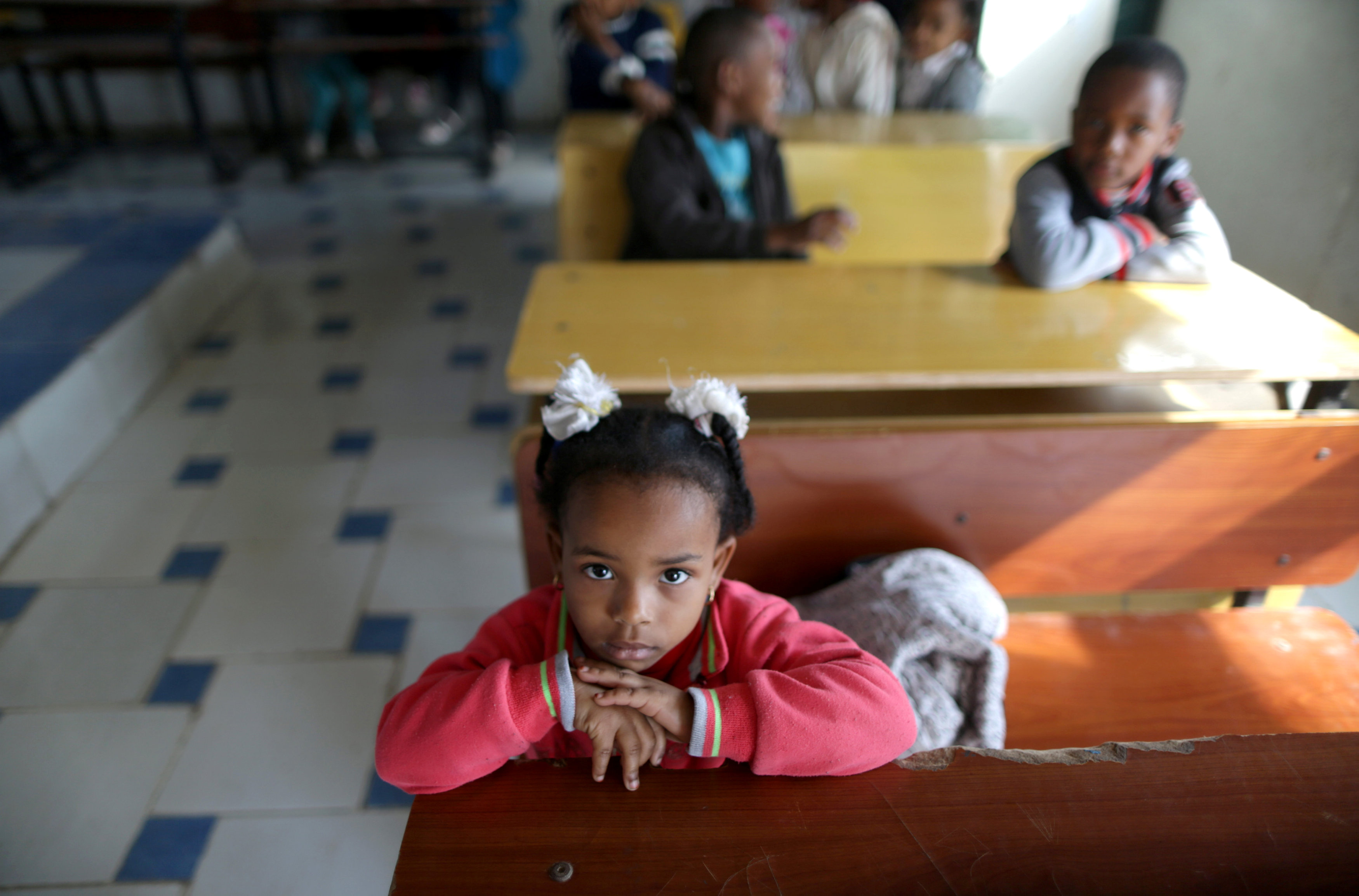 A Libyan child displaced from the town of Tawergha poses for the camera in the class in the camp in Benghazi