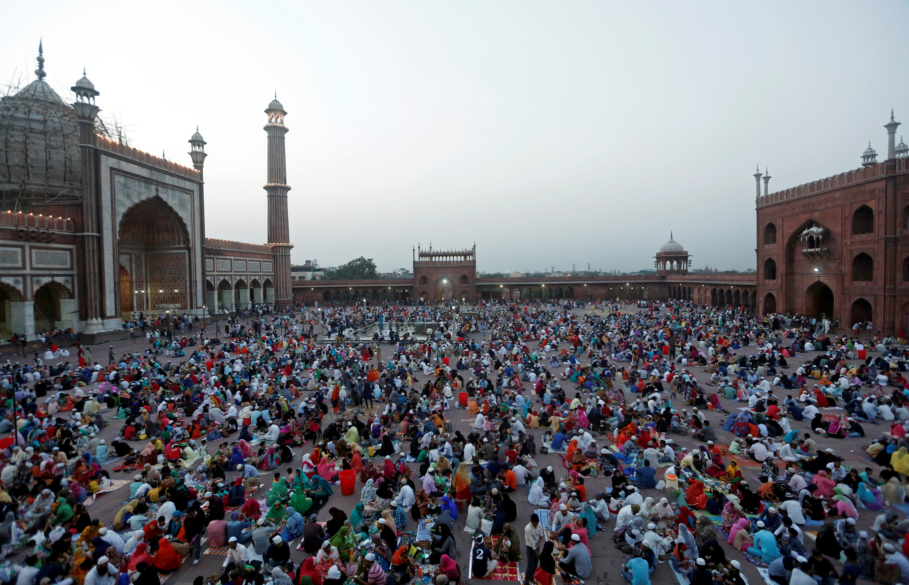 Muslims eat their iftar meal during the holy month of Ramadan at the Jama Masjid in the old quarters of Delhi