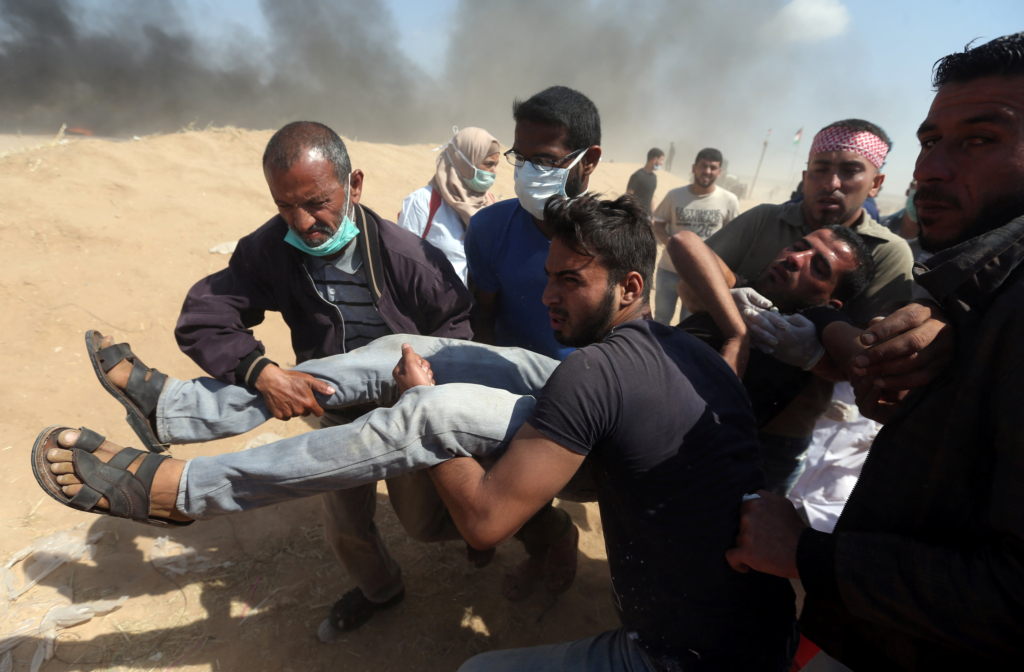 Wounded Palestinian demonstrator is evacuated during a protest marking the 70th anniversary of Nakba, at the Israel-Gaza border in the southern Gaza Strip