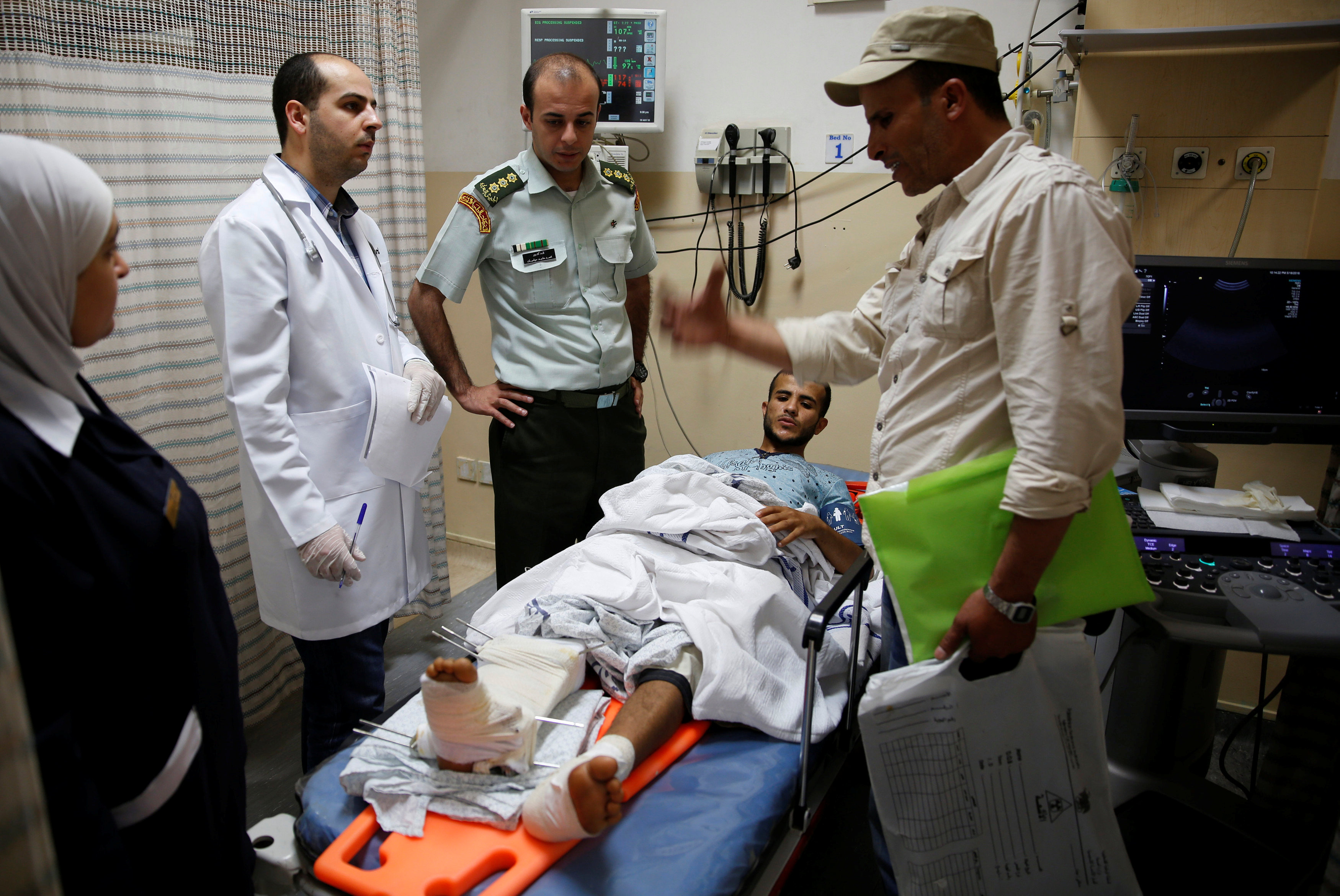 An injured Palestinian man from Gaza receives treatment after his arrival at the Al Hussein Medical Centre in Amman