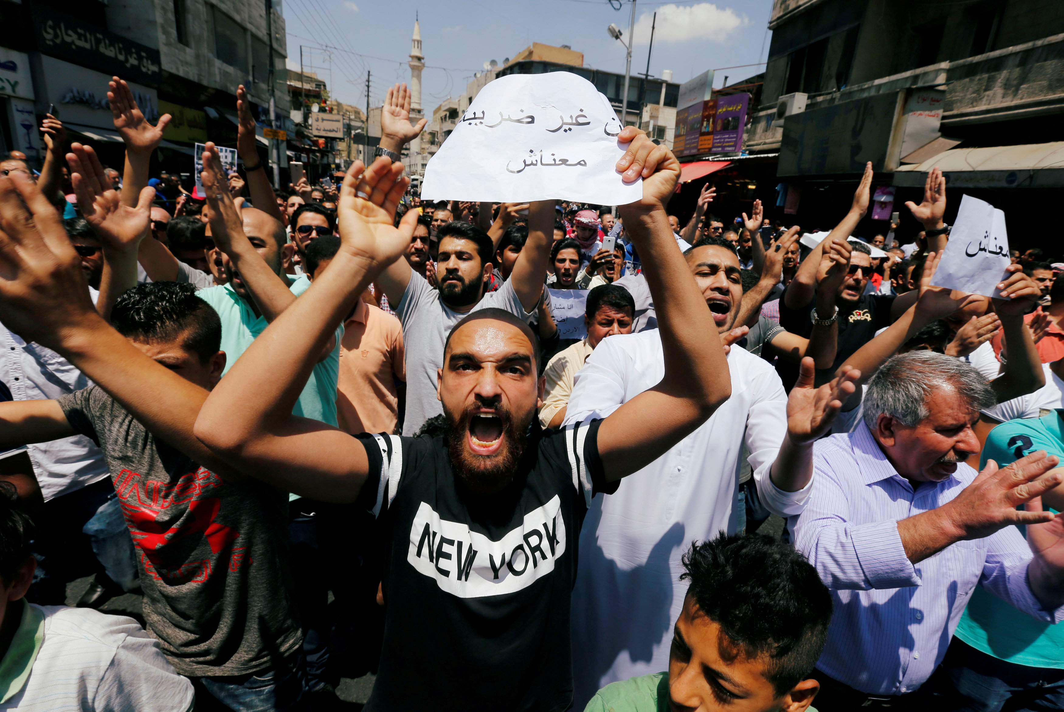 Protesters chant slogans during a protest against the new income tax law and high fuel prices, in Amman
