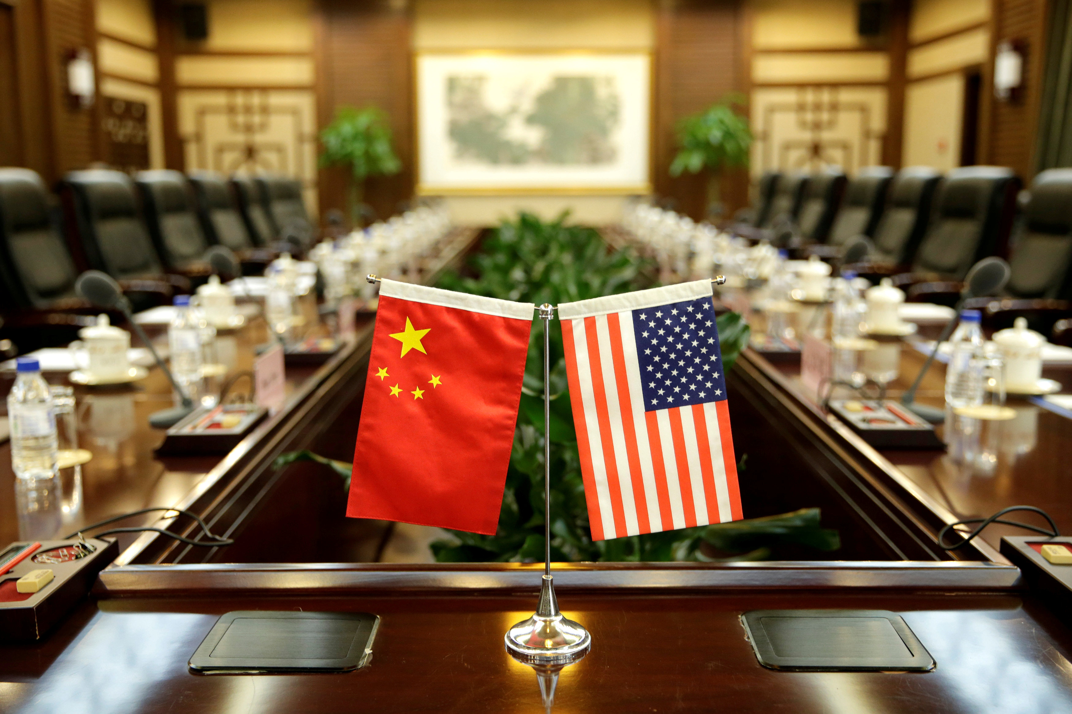 FILE PHOTO: Flags of U.S. and China are placed for a meeting in Beijing
