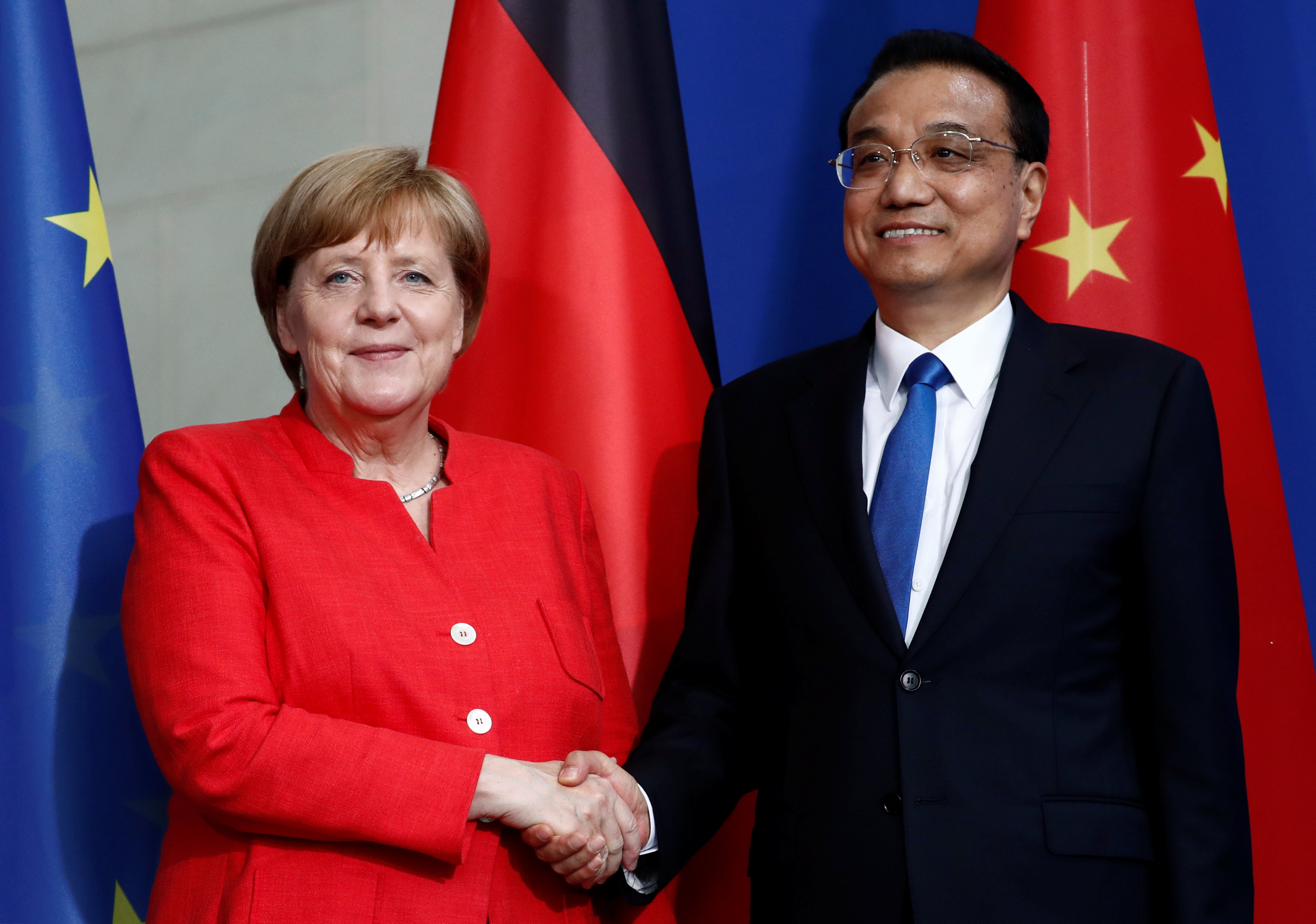 German Chancellor Angela Merkel and Chinese Prime Minister Li Keqiang shake hands after a news conference at the chancellery in Berlin