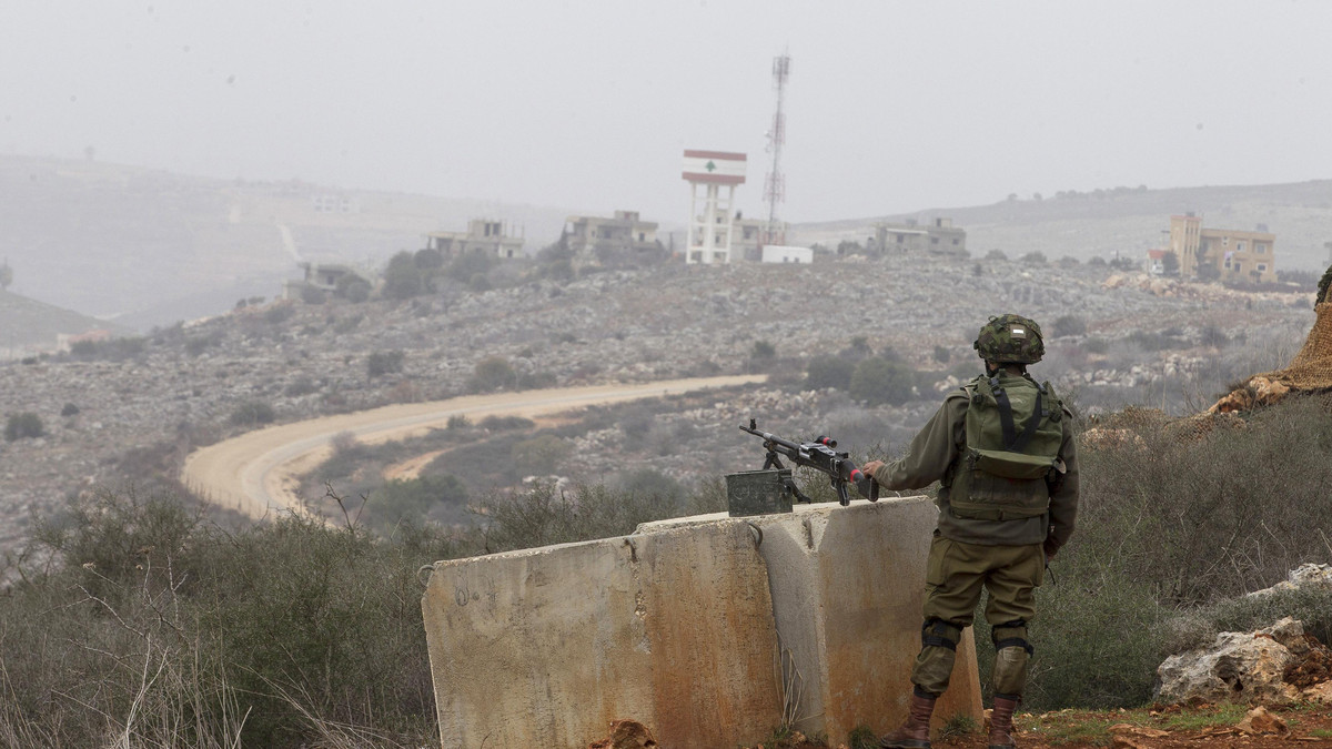An Israeli soldier monitors the Israel-Lebanon border from an observation point near Kibbutz Manara