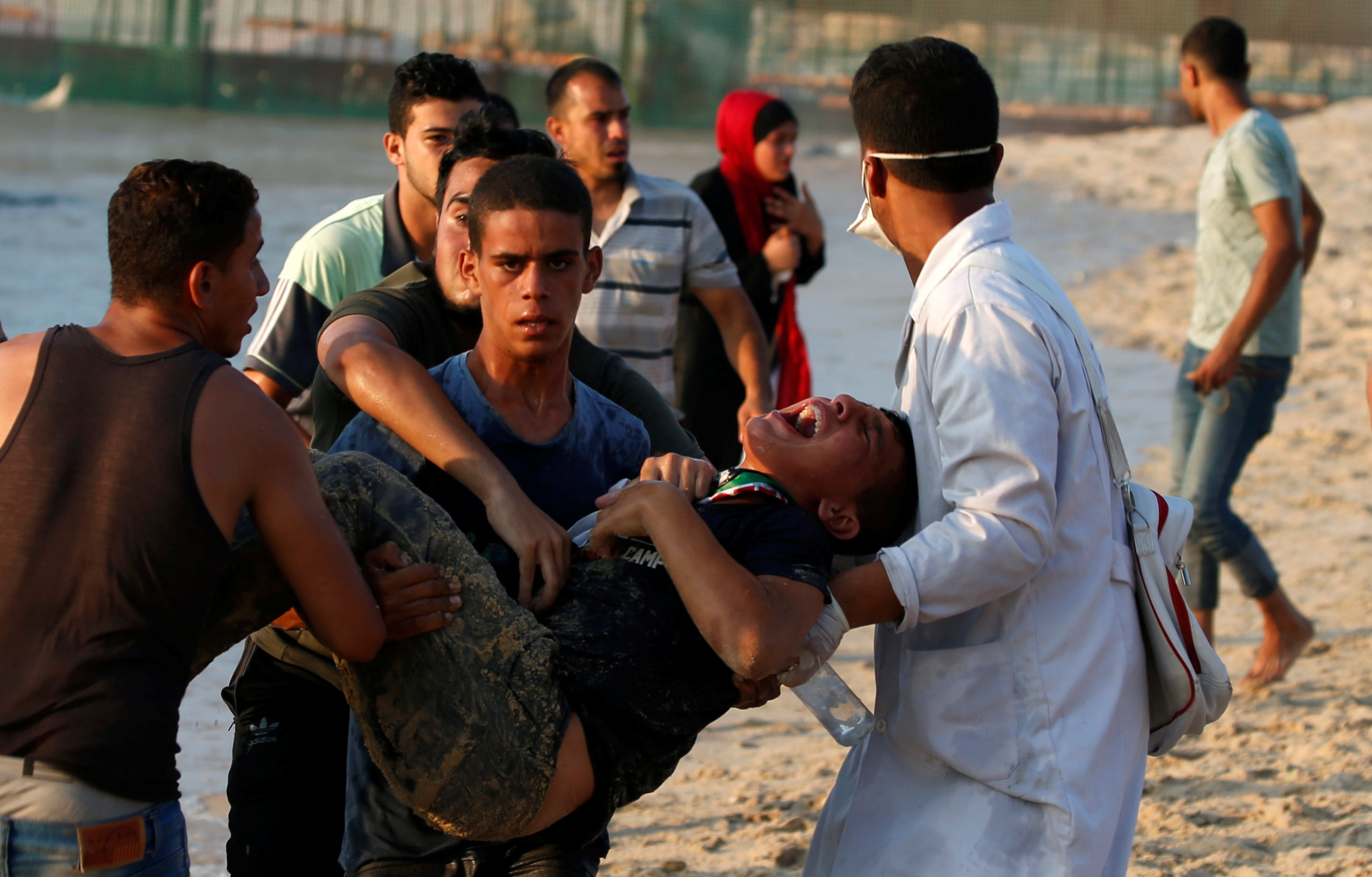 Wounded Palestinian is evacuated during a protest calling for lifting the Israeli blockade on Gaza, on a beach near the maritime border with Israel, in the northern Gaza Strip