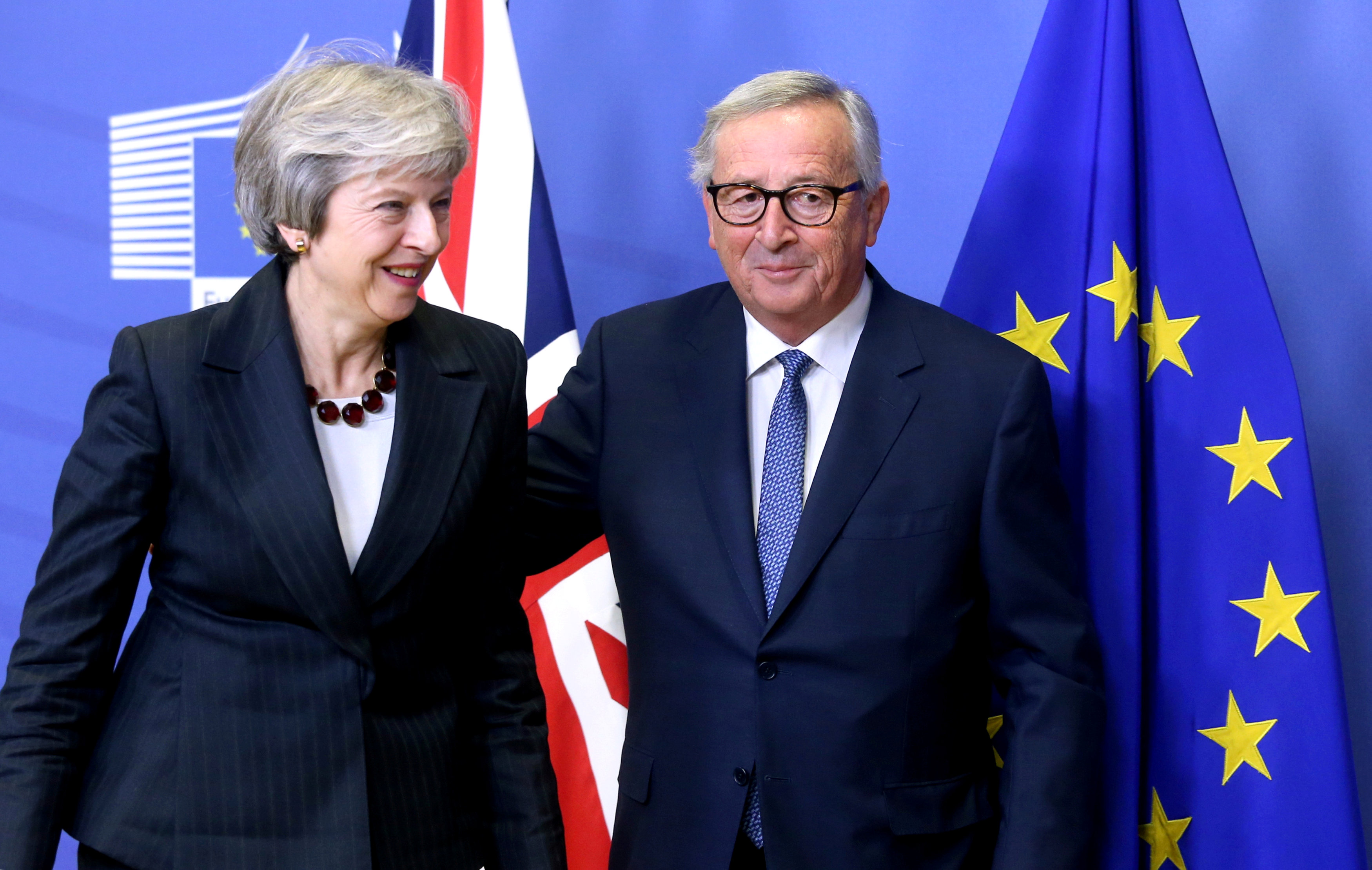 FILE PHOTO: British Prime Minister Theresa May and European Commission President Jean-Claude Juncker leave to discuss draft agreements on Brexit, at the EC headquarters in Brussels