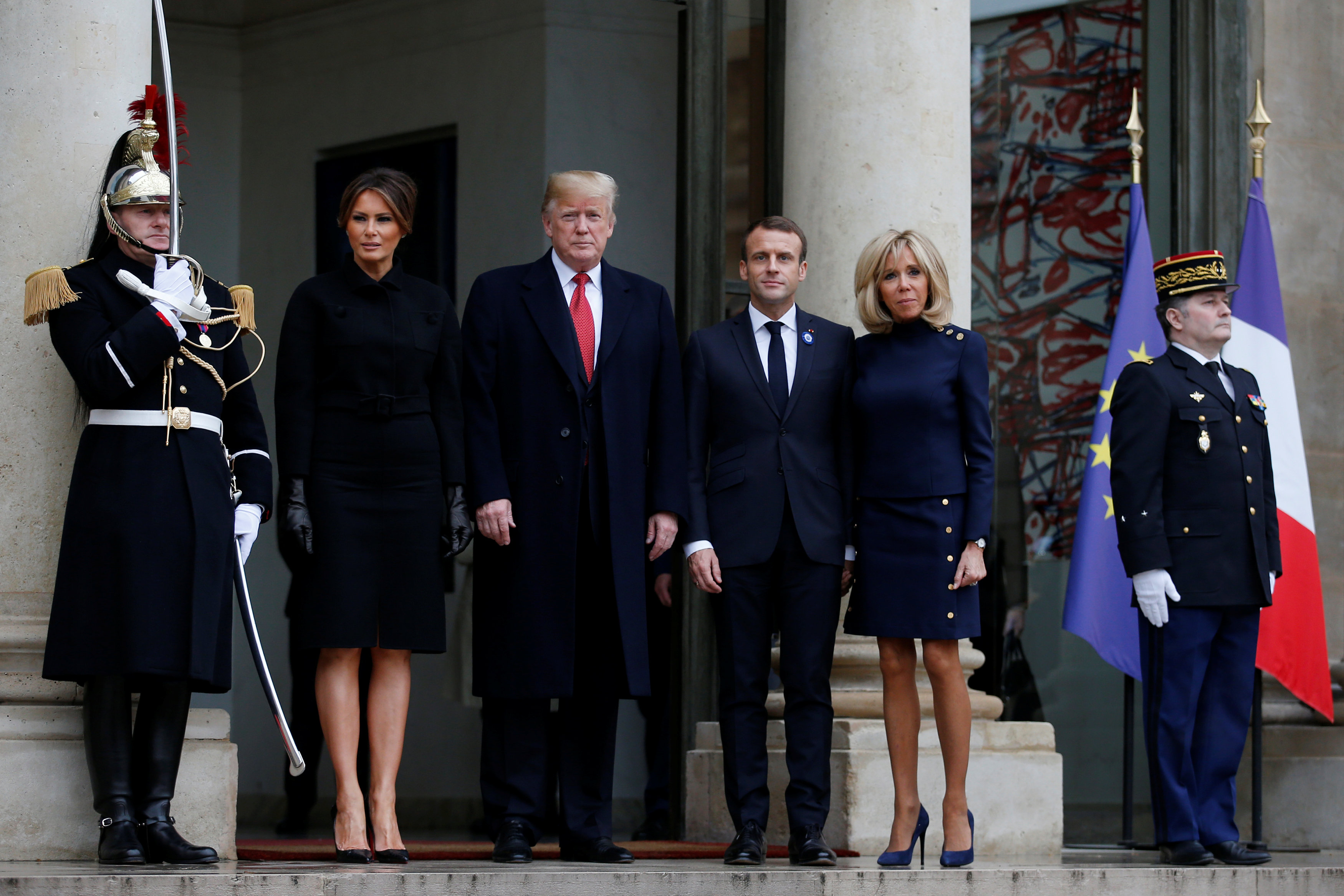 French President Emmanuel Macron and his wife Brigitte Macron accompany US President Donald Trump and first lady Melania Trump as they leave the Elysee Palace in Paris