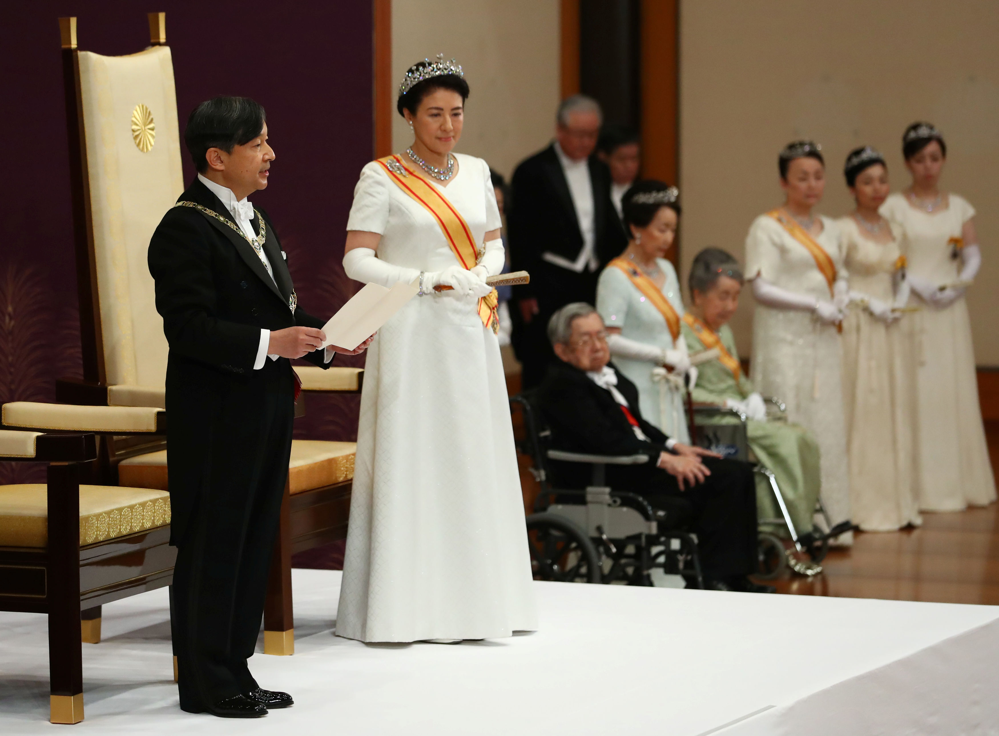 Japan's Emperor Naruhito, flanked by Empress Masako, delivers a speech during a ceremony called Sokui-go-Choken-no-gi, his first audience after the accession to the throne , at the Imperial Palace in Tokyo