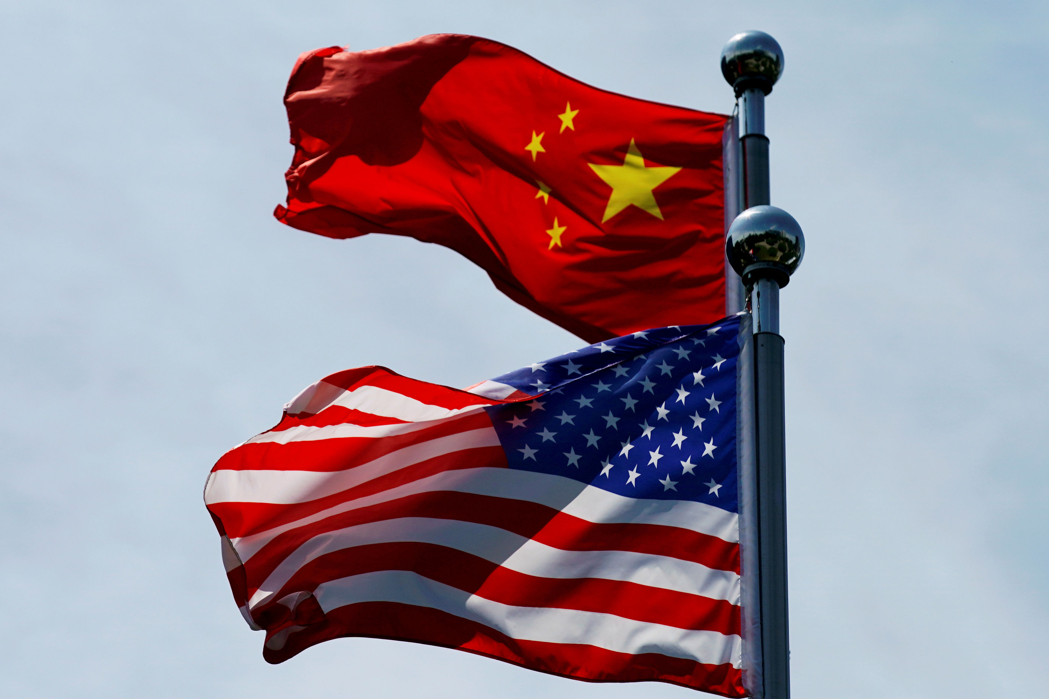 FILE PHOTO: FILE PHOTO: Chinese and U.S. flags flutter near The Bund in Shanghai