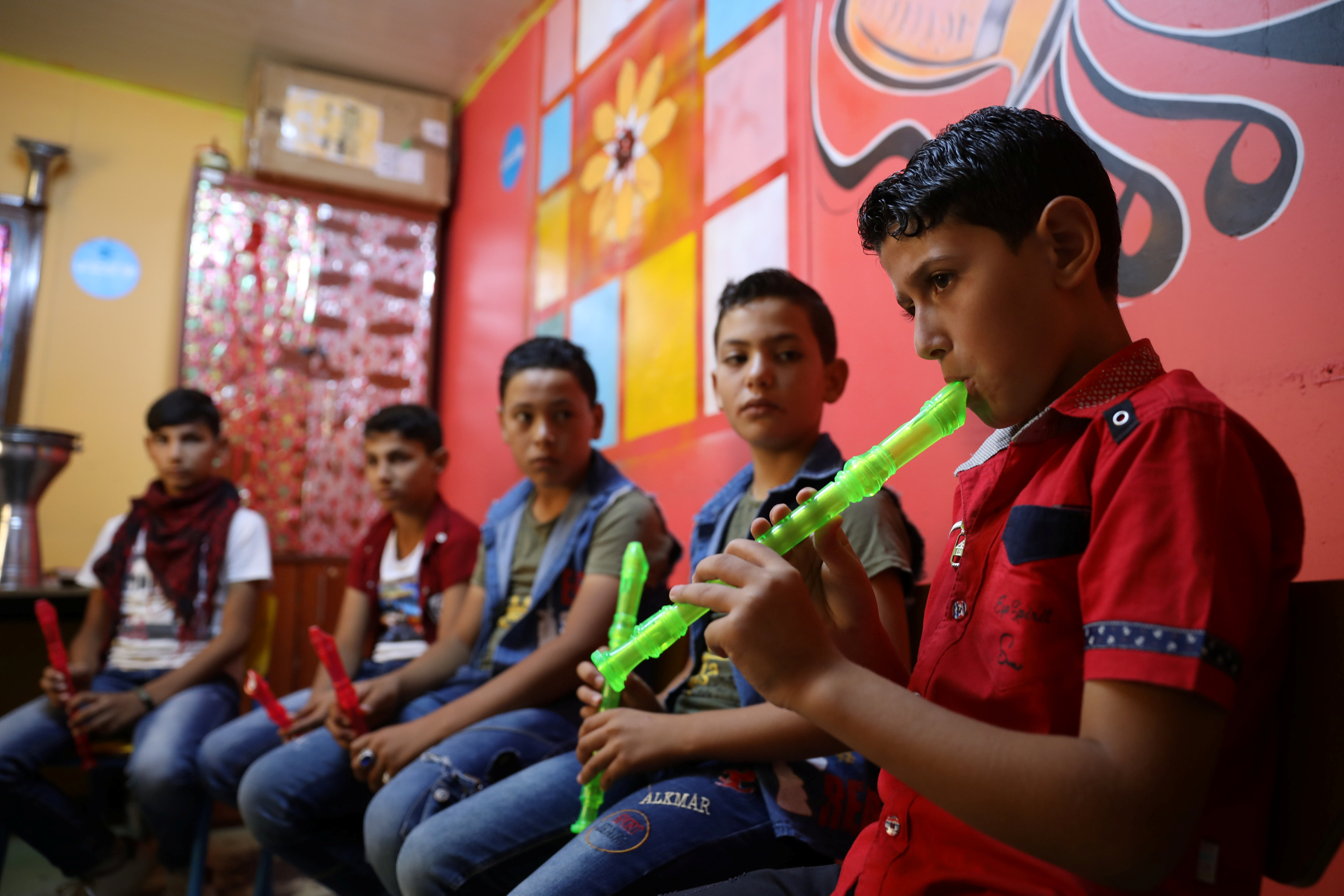 Syrian refugee children take part in UNICEF's Musiqati (My Music) program in the Al-Zaatari refugee camp