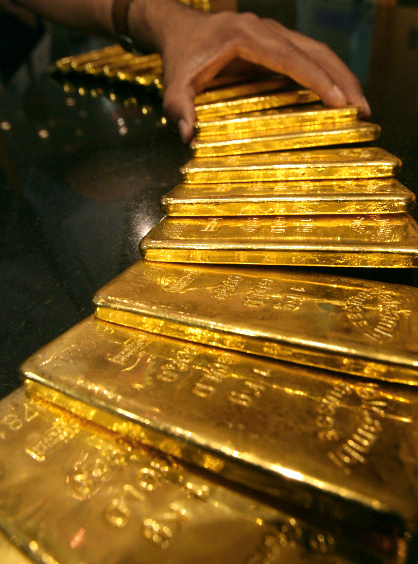 FILE PHOTO: Security guard places several one-kilo gold bars inside secured vault in Dubai