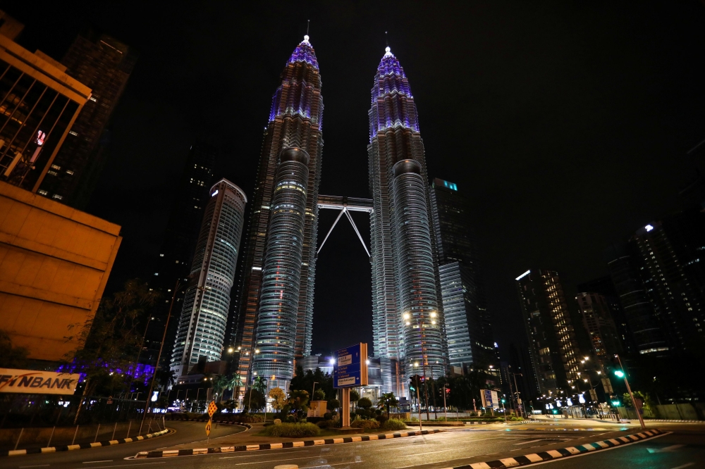 Petronas Twin Towers are seen illuminated in blue as part of the ?Light It Blue? initiative to honour front-line workers during the movement control order due to the outbreak of the coronavirus disease (COVID-19), in Kuala Lumpur