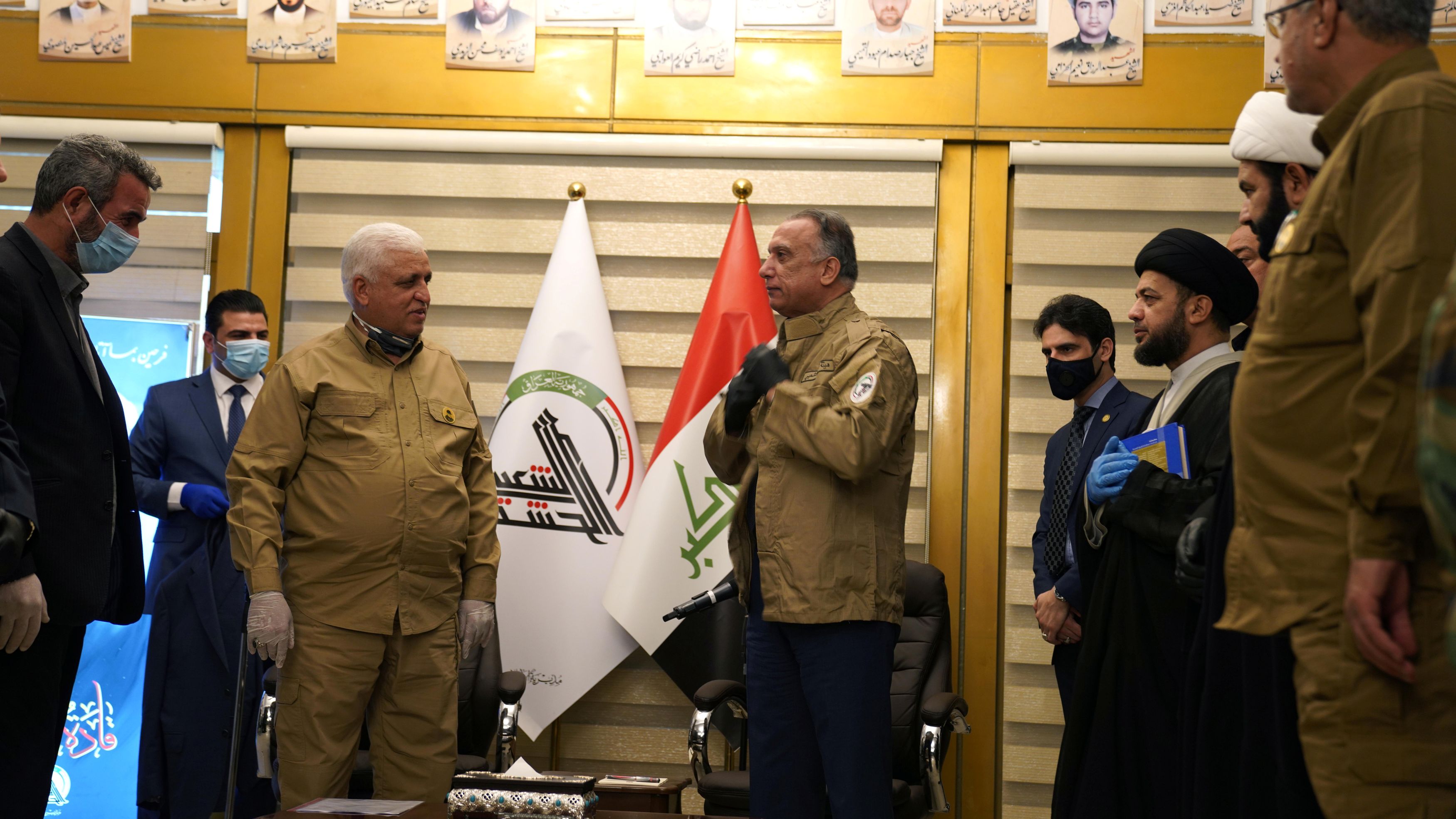 Iraqi Prime Minister Mustafa al-Kadhimi wears a military uniform of Popular Mobilization forces during his meeting with Head of the Popular Mobilization forces Faleh al-Fayyad in Baghdad