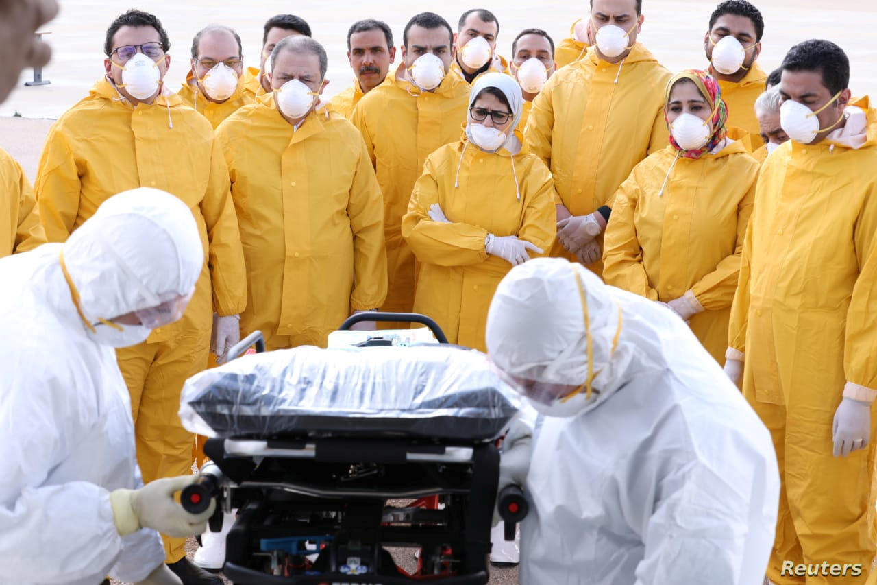 Egyptian Minister of Health Hala Zayed stands with a medical team at Borg El Arab airport, awaiting passengers that were evacuated from Wuhan, China, in Alexandria