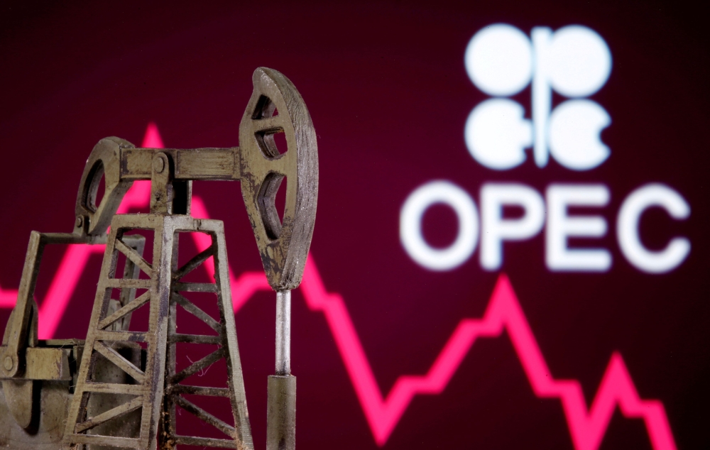 FILE PHOTO: A 3D printed oil pump jack is seen in front of displayed stock graph and Opec logo in this illustration picture