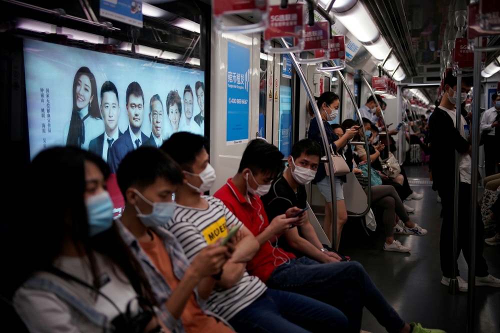 People wearing face masks are seen in a subway in Shanghai