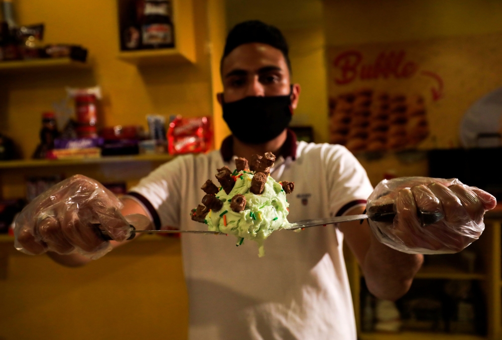 Egyptians enjoy coronavirus-shaped ice cream to cool down during summer in Cairo