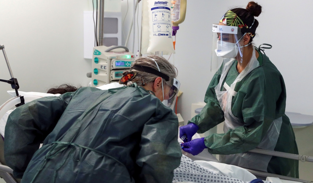 FILE PHOTO: Nurses care for a patient in an Intensive Care ward treating victims of the coronavirus disease (COVID-19) in Frimley Park Hospital in Surrey