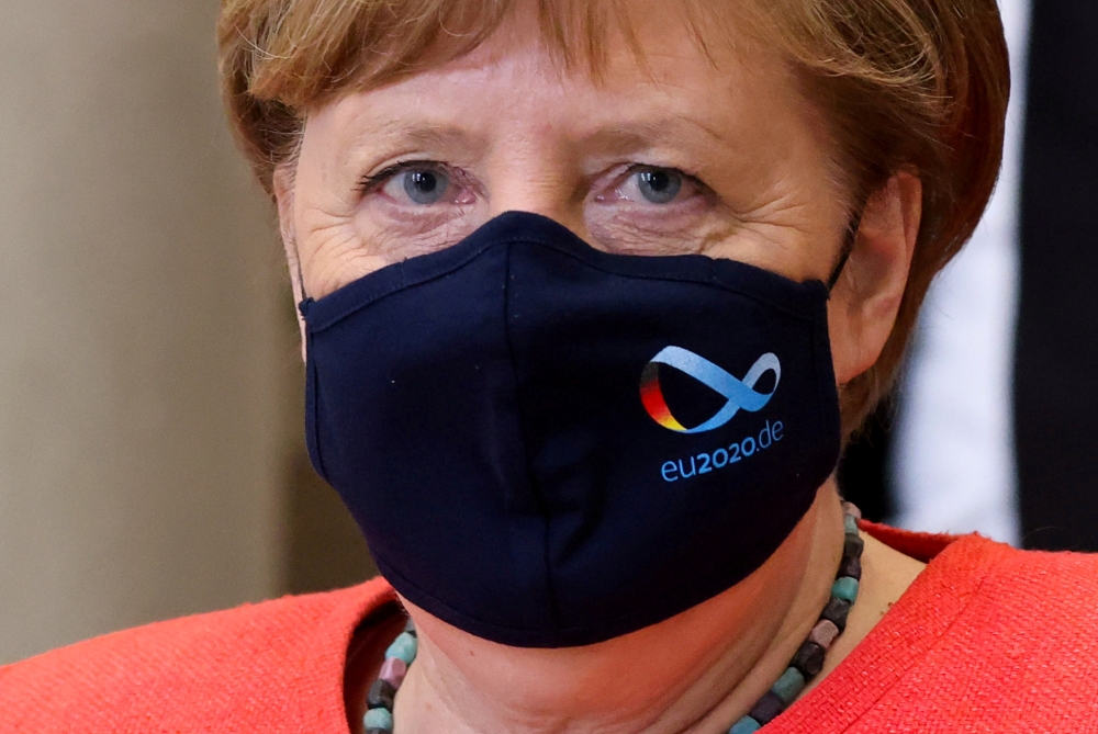 FILE PHOTO: German Chancellor Angela Merkel wearing a face mask is seen after a session at the upper house of the German parliament Bundesrat, following the outbreak of the coronavirus disease (COVID-19), in Berlin
