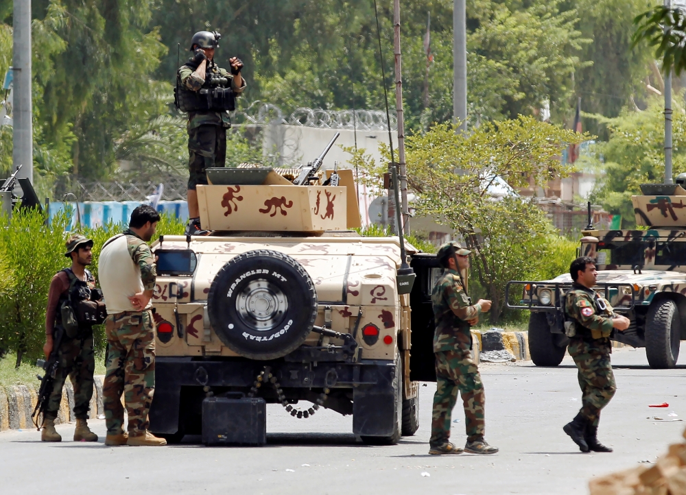 Afghan security forces arrive near the site of an attack on a jail compound in Jalalabad