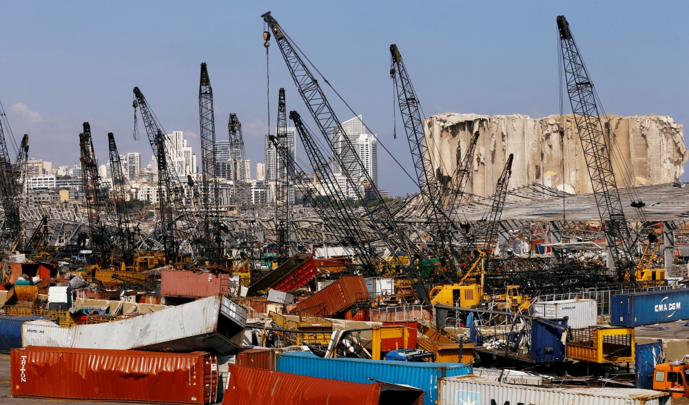 Debris and damaged vehicles are seen in the port area, after a blast in Beirut