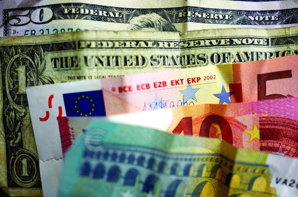 FILE PHOTO: U.S. dollar and Euro bank notes are photographed in Frankfurt, Germany, in this illustration picture