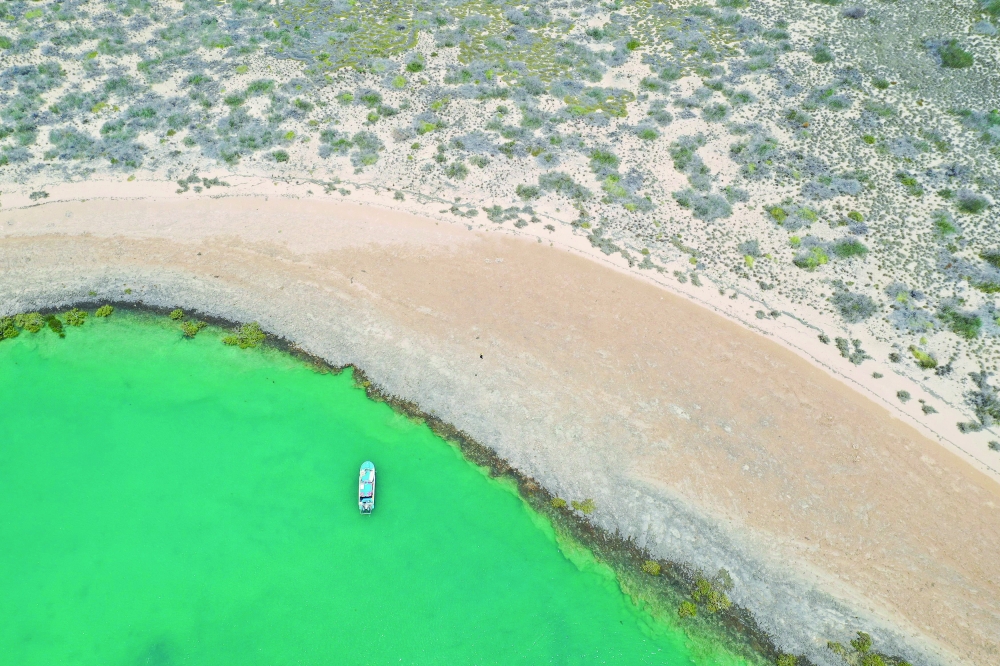 Aerial photo shows a vessel from Deep History of Sea Country surveying Dampier Archipelago in Western Australia