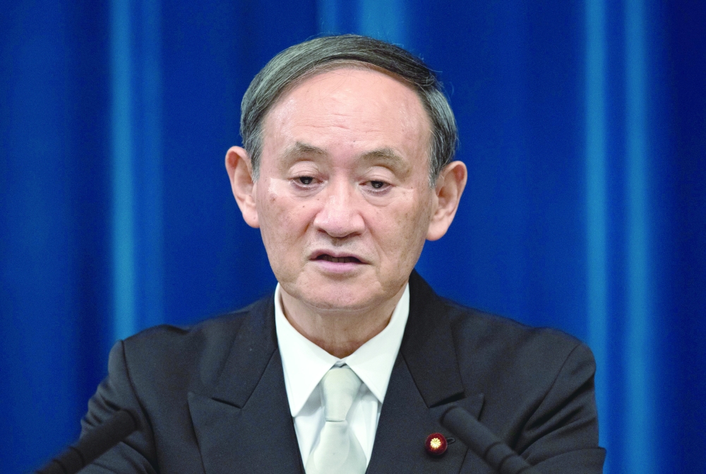 Yoshihide Suga speaks during a news conference following his confirmation as Prime Minister of Japan in Tokyo