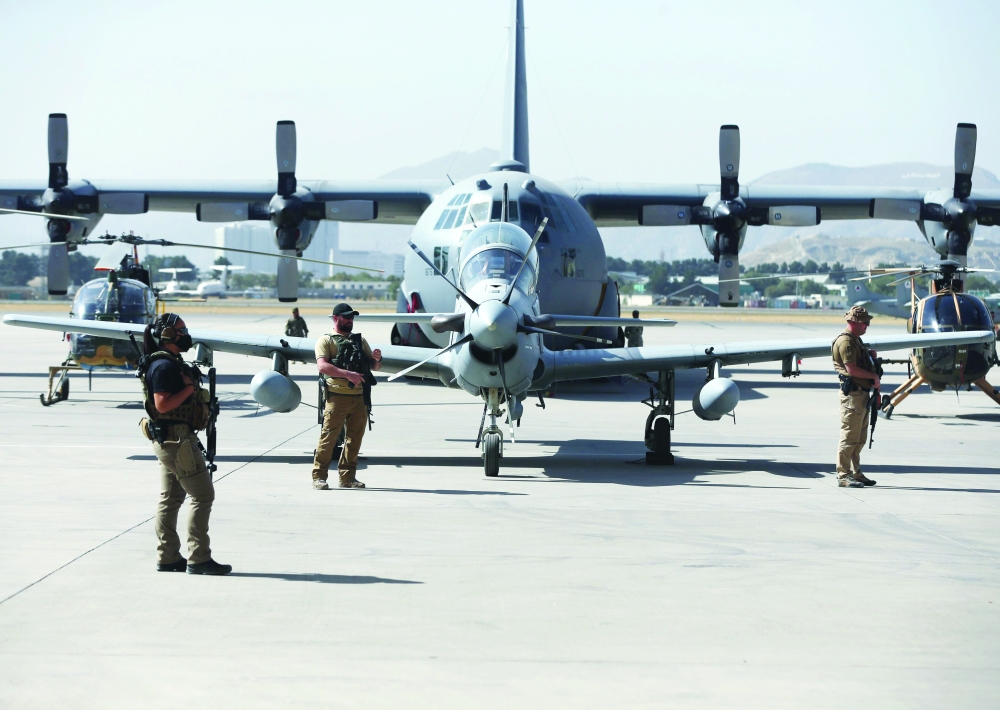 U.S. security personnel stand guard during a handover ceremony of A-29 Super Tucano planes from U.S. to the Afghan forces, in Kabul, Afghanistan