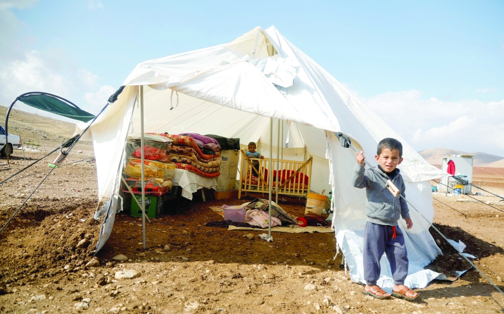 A Palestinian boy, whose family tented home was destroyed, stands outside a tent in Khirbet Humsah in Jordan Valley in the Israeli-occupied West Bank
