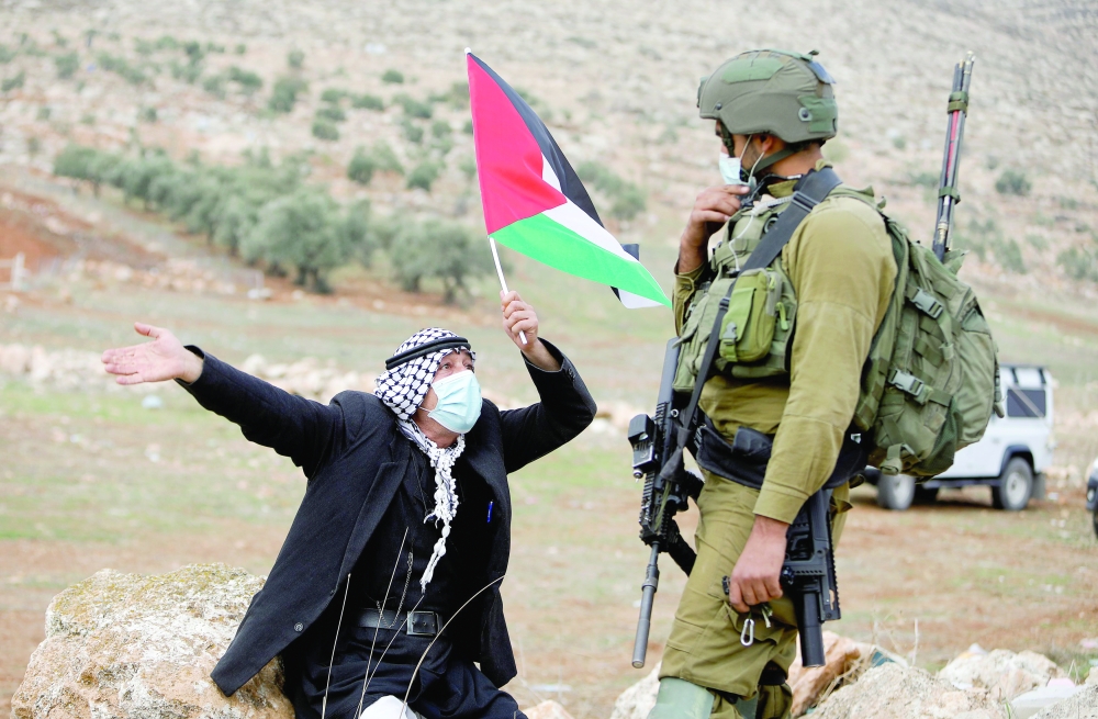 Palestinians protest against Jewish settlements in the Israeli-occupied West Bank