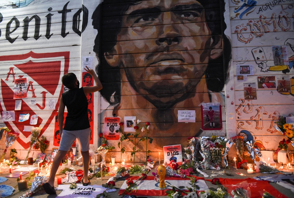 People gather to mourn the death of soccer legend Diego Maradona, outside the Diego Armando Maradona stadium, in Buenos Aires