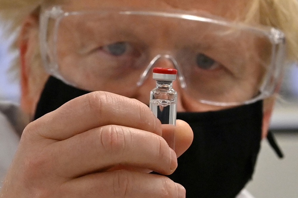 FILE PHOTO: Britain's PM Johnson sees coronavirus vaccine manufacturing process in Wrexham