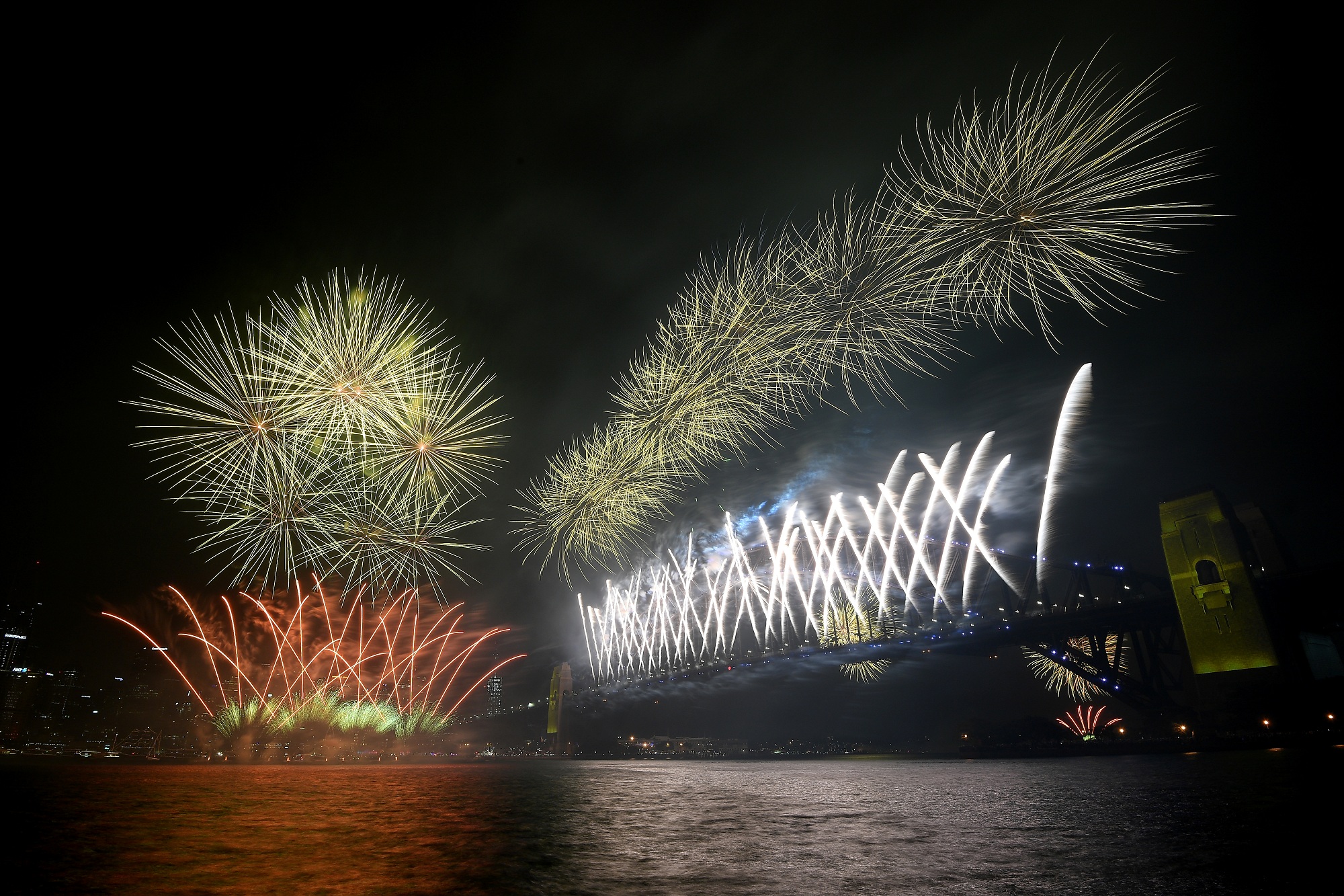 Fireworks explode above the Sydney Harbour Bridge, as seen from Kirribilli during New Year's Eve celebrations in Sydney